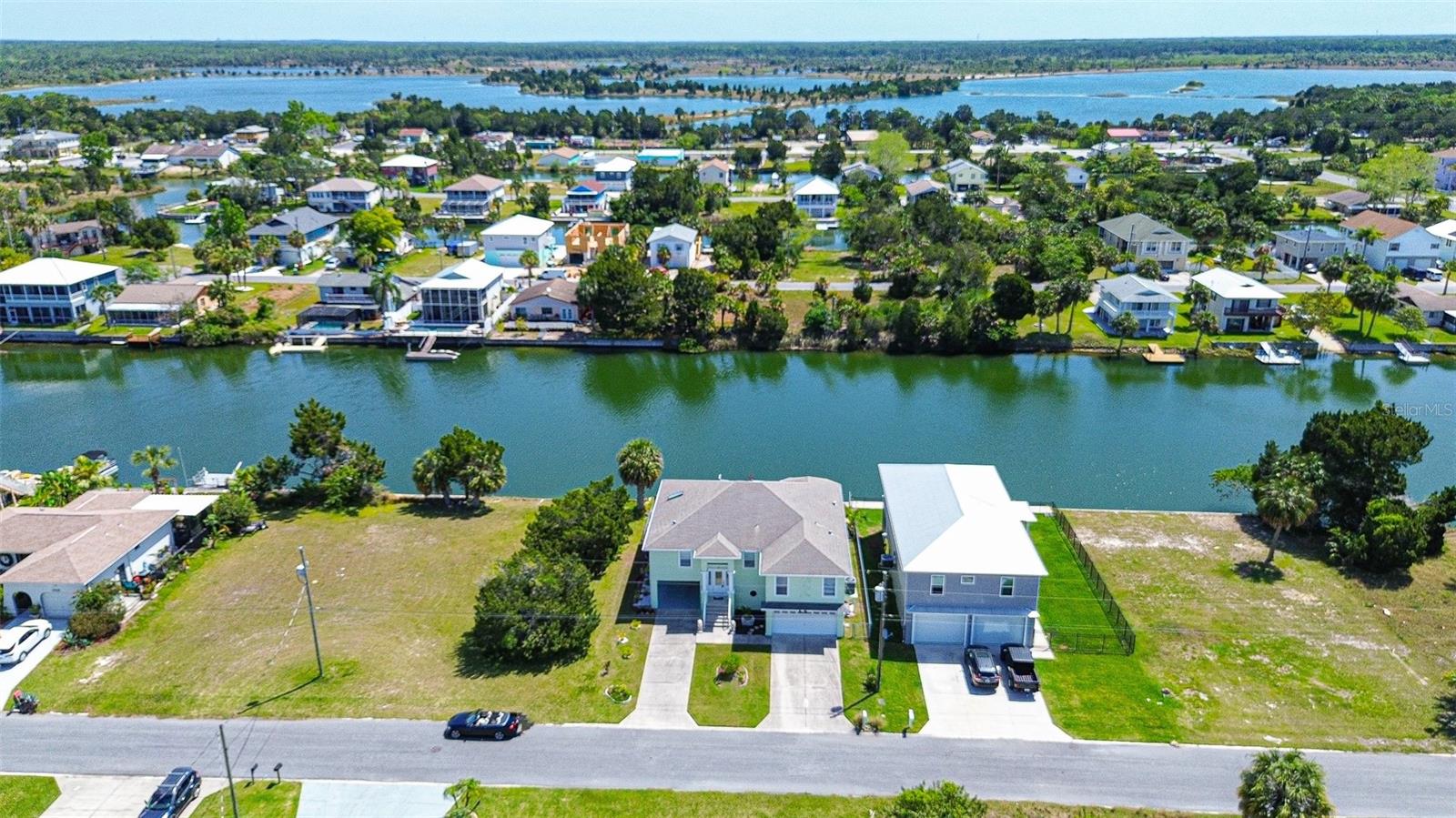 NO STORM DAMAGE HERE!! Stilt Home with ALL LIVING AREA ON UPPER FLOOR. PARTIALLY FURNISHED RENTAL (or unfurnished if preferred)! DEEP & WIDE WATERFRONT CANAL WITH GULF ACCESS! 1926 SQFT LIVING PLUS 300SQFT GLASS ENCLOSED LANAI (2226 SQFT TOTAL)! **SPACIOUS 4-6 CAR GARAGE!** Immerse yourself in the boating and fishing village of Hernando Beach! Envision a life where boating adventures, breathtaking sunsets, and the soothing rhythm of the water are just steps from your door! Enjoy breathtaking GULF WATER VIEWS FROM NEARLY EVERY ROOM! OPEN-CONCEPT WITH HIGH CEILINGS, bamboo flooring & an ABUNDANCE OF NATURAL LIGHT adding warmth and gentle illumination! Slider doors open to a GLASS ENCLOSED BALCONY creating the perfect backdrop to enjoy daily sunrises with your morning coffee. The kitchen features SS appliances, plenty of white cabinets with glass showcase features, breakfast bar seating & breakfast nook with stunning water views. The primary bedroom offers private access to the lanai! En suite bathroom with ''his and hers'' areas including make-up vanity and large walk-in shower! HUGE SECOND BEDROOM with water views, nice size 3rd BR. Convenient inside laundry room, central vac system, and equipped with an ELEVATOR SHAFT (no elevator -- electric ready) -- making for great storage space now! YOU’LL FALL IN LOVE WITH THE SIZE OF THIS GARAGE - AS LARGE AS A 6 CAR GARAGE – The ultimate man-cave, PARK ALL YOUR TOYS, your sports car, golf cart, motorcycle, boat. Create a game or fitness room, or workshop! PLUS DEEP TWO CAR CARPORT for additional parking! Glass sliders from garage open to the covered patio, enjoy the water views as you lounge in the shade, bask in the sun, or enjoy open air dining .. listen to the birds and enjoy the summer breezes. Cast a pole from your backyard and see if you can catch some dinner. From the floating dock you can launch your kayaks, tie up your small craft or pontoon boat. This home is on a saltwater canal that has indirect access to the Gulf of Mexico. To reach the Gulf your boat must go through a private, community boat lift. Or you can dry dock your boat at a marina just blocks down the street. No HOA and no CDD. Added features include: Hardy board siding, hurricane impact garage door, hurricane impact windows. FLORIDA'S ADVENTURE COAST is known for its natural beauty, water-based activities, and proximity to outdoor adventures. Indulge in boating, fishing, and wildlife watching. It's also close to some amazing locally-owned restaurants like The Silver Dolphin, Hernando Beach Tropical Grille, Trader Bay Seafood, & Sharky’s Bar and Grill. You’re only minutes away from Weeki Wachee Springs State Park where you can explore waterslides and mermaid shows. You’re also close to Roger’s Park and Pine Island Beach. US-19 is conveniently nearby, so travel to Homosassa, Tarpon Springs, or Clearwater is easy. Come home, THE WATER IS CALLING ... make an appointment to view this one before its gone!