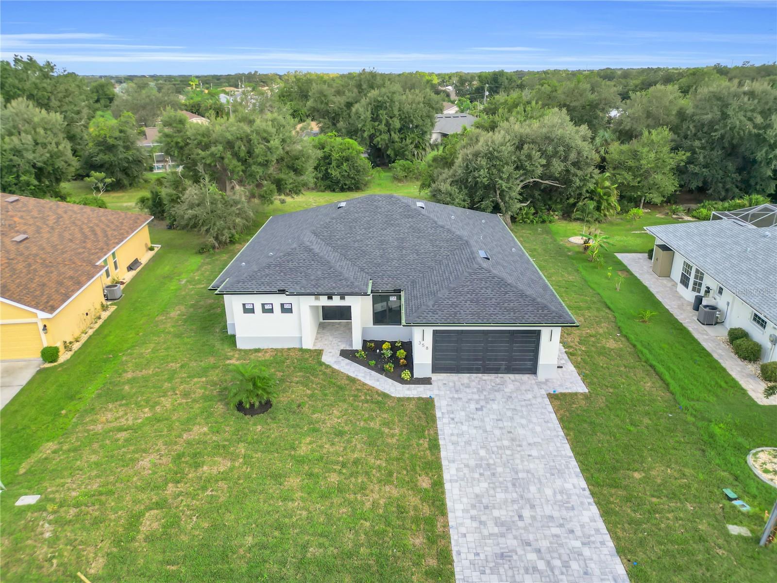 This elegant 4-bedroom, 3-bathroom home perfectly combines comfort and sophistication. Designed with an open layout, it features a stunning kitchen with high-end appliances, a built-in oven, a decorative range hood, and a spacious island that brings beauty and functionality to the home. The bathrooms are spacious, each with elegant illuminated mirrors that enhance their contemporary design. Outside, a private terrace with a fully equipped summer kitchen provides the perfect setting for entertaining guests or simply enjoying the year-round Florida sunshine. Located in the coveted Deep Creek community, this property is just a short drive from pristine Gulf Coast beaches, golf courses, and a variety of restaurants.