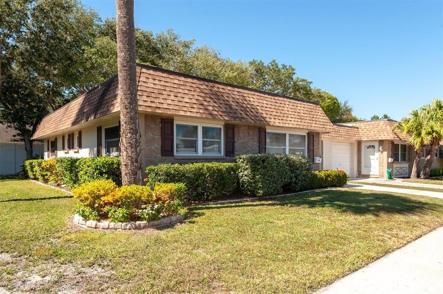 Stunning end unit villa 2 bedrooms 2 bathrooms, 1 car garage. Welcome home to your 55+ dream villa in the heart of Largo, with private access to Largo Rec's 17 million dollar facility. This Meticulously maintained 2 bed 2 bath villa is the epitome of modern comfort and convenience. Enjoy ample space in the two generously sized bedrooms. Two beautifully appointed bathrooms, which were remodeled in 2022, offers style and comfort, completed with modern fixtures and quartzite countertops and a primary en-suite for your convenience. The open living area features a seamless flow between the living room, dining area and kitchen, creating a perfect space for entertaining. The fully equipped kitchen boast Stainless steel appliances, granite countertops, glass subway backsplash, and a peninsula with bar seating. The back yard is spacious and has white PVC fencing for your privacy. You'll love the convenience of the privately attached 1- car garage providing both storage and secure parking. Updates include new windows 2021, new doors, new laminate floors, fixtures, ceilings, an updated electrical panel, water softener, interior paint and crown molding. This turn key property will not last long, hurry make your appointment today before this villa slips away