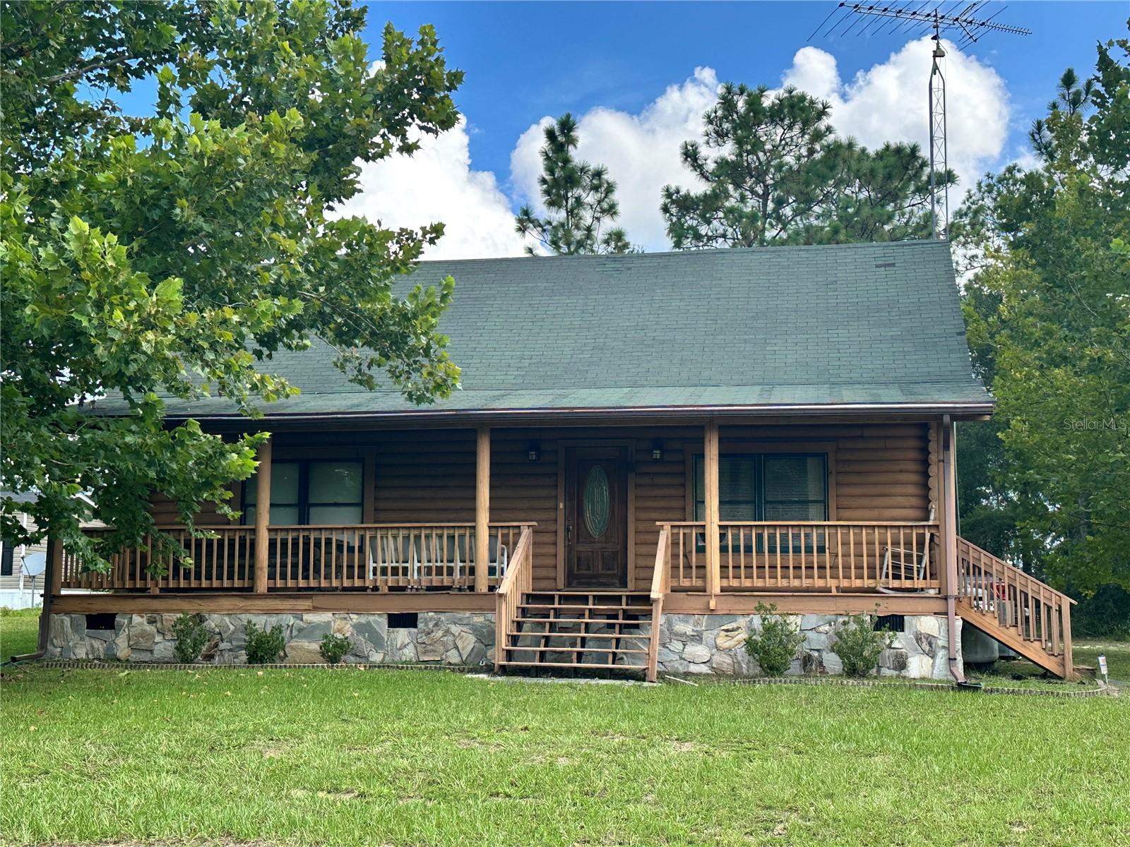 Discover the perfect blend of rustic charm and modern comfort in these 3 bedrooms, 2-bathroom log cabin home nestled on .56 acres in the heart of Bronson. Boasting 1,320 sq ft of living space, this two-story home offers a warm, inviting atmosphere with its natural wood finishes and cozy layout including a beautiful loft overlooking the living and dining rooms! Unlike many others this beautiful home comes fully furnished! Relax and enjoy the peaceful surroundings from your spacious front porch, ideal for morning coffee or evening sunsets. Outside, you’ll find a shed for extra storage and a carport to keep your vehicle protected from the elements. Located in a quiet setting yet close to local amenities, this property is perfect for those seeking small-town living with room to breathe. Whether you’re looking for a full-time residence, a weekend getaway, or a unique investment property, this Bronson log cabin is ready to welcome your home.
