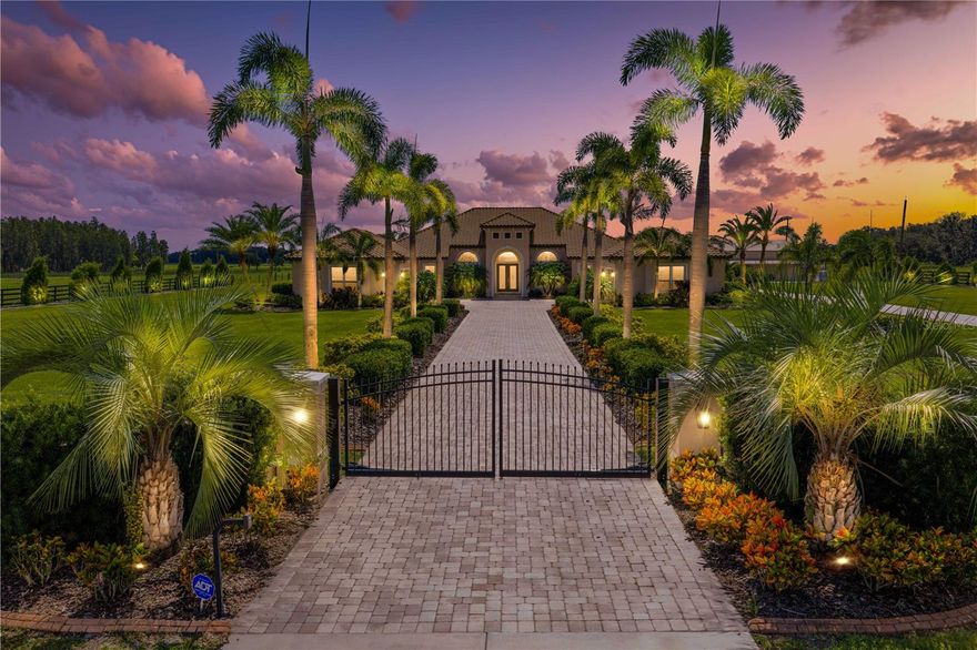 Under contract-accepting backup offers. Welcome to this treasured and exclusive luxurious country estate sitting on 7.5 acres in southern Hillsborough County. Featuring exceptional custom design and amenities, with the opportunity to turn the property into your dream family compound with three guest suites on the property, or personal country resort. Enjoy the peace and beauty of this slice of country heaven, all while living just a short drive from daily conveniences and city life. Shops and every-day needs are only 10 minutes away, 30 minutes to city of Tampa, 50 minutes to the airport, and an hour to the beach. You'll retreat home to your personal country resort, zoned AR, allowing for equestrian uses, farm operations, and agricultural activities, if so desired.

Approach the gated residence, head down the paver driveway with luxurious landscaping and elegant lighting, and up to the custom built residence. The main home provides 4 beds, 3 baths, 3,262 heated SF, and 6-car garage, totaling 6,151 SF. The single-story residence, just completed 5 years ago, with top of the line custom design features, block construction, tile roof, whole home generator, and more. Open concept design plus a split floor plan, provides functional and modern living space. Primary suite features his-and-hers walk-in closets, spa-like bath, safe room, and sliding doors to the outdoor oasis. 

Step outside to your resort-style paradise, luxury pool and spa, full outdoor kitchen, outdoor shower and entertainment space. The pool house is one of three ADUs on the property. This guest house provides 1 bed/1 bath and 575 SF of comfortable living for family or guests with the glamorous pool view. Adjacent is a custom-designed Pergola with fire pit surrounded by seating. Lush landscaping design surrounds the property, with over 120 palm trees and a 20-zone irrigation system with water treatment system. Continue your journey through the property, to discover the unique gems of the estate. A fully-finished nearly 6,000 SF luxurious pole barn, completed in 2024, with two identical 1 bed/1 bath apartments (700 SF each) + steam room, laundry and spa-like set up. A movie theater with eight vibrating 4D theater seats, bar seating, custom movie theater carpet, 8K Sony projector with 185-inch acoustical screen. Plus, a bar area and 1950s diner-themed game room make this space one-of-a-kind! This barn also features an enclosed office, home gym, second-level loft for more unique space, dog bath, parking for boats, RVs, cars, etc. With the epoxied flooring, the space could even be used to host events. The back balcony overlooks the beautiful acreage of the property currently set-up as a skeet shooting range.

An additional 3,000SF metal barn sits on the property for all storage needs, additional recreational vehicle or tractor parking, accessible by the second driveway. The property is fully fenced with coded gate access.

The comfort of luxury living in a country setting awaits, where the opportunities here are endless and the space is rare and breathtaking. Come tour your dream property today. (See attached Feature Sheet in MLS or contact agent for Full Feature Sheet & Property Video)