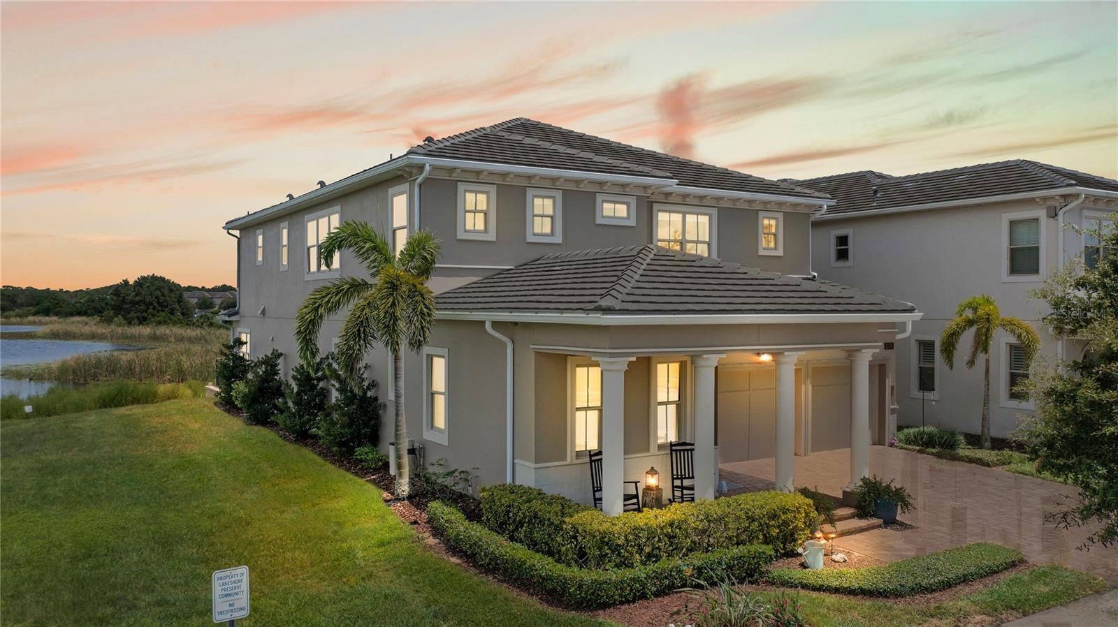GORGEOUS, MOVE IN READY, fully upgraded home in Winter Garden’s desirable Lakeshore Preserve. Located on a premium waterfront lot with green space on one side, this Toll Brothers “Madeira” floor plan features 5 beds, 4.5 baths, with the expanded option, making the kitchen and owner’s suite larger and adding a balcony off the owner’s suite, in addition to a formal dining room, large upstairs loft, 3-car tandem attached garage, is SOLAR POWERED and the solar is PAID OFF! The upgraded barrel ceiling in the foyer welcomes you into the home and you will love the open and bright floor plan featuring 10’ ceilings downstairs and 9’ ceilings upstairs. You’ll love the expanded, gourmet kitchen with upgraded cabinets, hardware and faucets, the bottom cabinets have pull out drawers and a wood plank backsplash accent wall. A large center island with a breakfast bar and butler pantry make this kitchen perfect for entertaining! The kitchen is open to the spacious family room that has a tray ceiling and pocket sliders that open to the extended screened in patio with a gorgeous water view! The patio is pre-plumbed for an outdoor kitchen with water and natural gas hookups. There are curtains on a track on the patio if you want privacy, too. What a great space for entertaining, or to enjoy your morning coffee or unwind after a long day! The yard is fenced with lights, has a retaining wall and a 10x10 paver patio outside of the screen enclosure – what a great place for a fire pit! There is a bedroom and full bath downstairs – perfect for visiting guests to have their own space! A remodeled half bath is downstairs as well. The 3-car tandem garage has epoxy floors and additional storage and shelving. The rest of the bedrooms are upstairs, surrounding the large loft space. The spacious owner’s suite has extra wide French doors that lead to the extended, covered and screened-in balcony with a gorgeous water view. The en-suite bath features two separate vanities with new lighting fixtures, a large soaking tub and a glass enclosed walk-in tiled shower. The large walk-in closet has built-ins to maximize the space. The guest bedrooms surround the loft. Two bedrooms share a jack-n-jill bath with a two-sink vanity and a tub/shower combo. One guest bedroom has its own en-suite bathroom with a one sink vanity and a tub/shower combo. One guest bedroom has a great setup as a craft room or office. The laundry room is upstairs for convenience as well. This home has been beautifully upgraded with a PAID OFF 10.8 kw solar panel system, making the electric bill only $100 per month, new exterior paint using Tuff Coat paint to guard against UV rays and moisture and comes with a transferrable warranty, custom light fixtures throughout, custom built-ins in the entry closet, kitchen pantry and owner’s closet, additional recessed lighting, upgraded hardware throughout, all showers have floor to ceiling tile, the home has a central vacuum and high speed internet in the bedrooms and living areas. You can even watch the Magic Kingdom fireworks nightly from almost every room in the home! Lakeshore Preserve has great, resort style amenities with a lakefront clubhouse, resort style pool, fitness center, playgrounds, dog park, sand volleyball, canoes and neighborhood activities. Live in the heart of the Hamlin area, close to great shopping and dining, major roads and highways. You can enjoy the luxurious lifestyle that Lakeshore Preserve offers – make this home yours today!