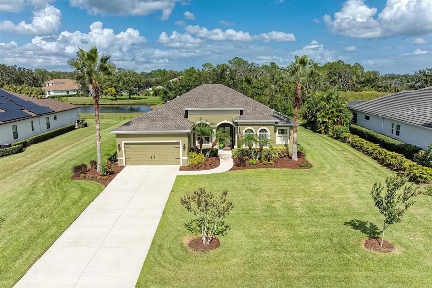Welcome to Twin Rivers, nestled within this sought-after community known for its estate-sized homesites, custom residences, and direct access to the Manatee River, this stunning Medallion-built Barbados floor plan offers the perfect balance of luxury and livability. Ideally positioned over 1/2 an acre with lush preserve and pond views, this property ensures privacy with no direct rear neighbors. Enter through elegant custom glass double doors into an inviting open-concept layout featuring a spacious living and dining area that flows seamlessly to the expansive outdoor living space. The screened lanai has been beautifully renovated and features several covered lounging and dining areas, a heated saltwater pool, and custom outdoor cabinetry with sink (2022) creating an idyllic year-round retreat. The chef’s kitchen is both stylish and functional, showcasing abundant cabinetry, a built-in desk, some upgraded appliances (2022–2023), and modern pendant lighting. A butler’s pantry conveniently connects the kitchen to the dining room, while the breakfast nook and family gathering room with sliders leading to the pool—make effortless entertaining. The primary suite offers a private sanctuary with slider to pool, a walk-in closet and a luxurious bath featuring dual sinks, newer quartz countertops, a soaking tub, linen storage, zero-entry and frameless glass shower that connects to the den/office. A separate guest wing includes two bedrooms and a shared bath with pocket-door privacy, while a 4th bedroom—with built-in shelving that can be easily removed, and nearby pool bath offers flexibility for guests. The outdoor space is a gardener’s delight, complete with four newer Vego raised-bed garden system, featuring automatic and adjustable irrigation—ideal for growing herbs, vegetables, or flowers. Fences are permitted, allowing plenty of room for pets and play. Recent updates reflect thoughtful care and attention to detail: NEW ROOF (2023), electric pool heater (2022), pool screen restoration (2023), interior paint (2022; 2025 refresh), laminate flooring in bedrooms (2022), updated lighting and fans, whole-home water filtration and softener system (2022), smart irrigation controller (2022), and hurricane shutters for peace of mind. Residents of Twin Rivers enjoy an exceptional lifestyle surrounded by nature and community amenities, including a riverfront park with boat launch, fishing pier, kayak storage, playground, and sports courts. With low HOA fees, no CDD, and a prime location near Rye Road to Lakewood Ranch, the Gamble Creek Farmer’s Market, and the Manatee River—with convenient access to St. Petersburg, Tampa, and Sarasota—this home offers the perfect blend of quality, comfort, and outdoor living.