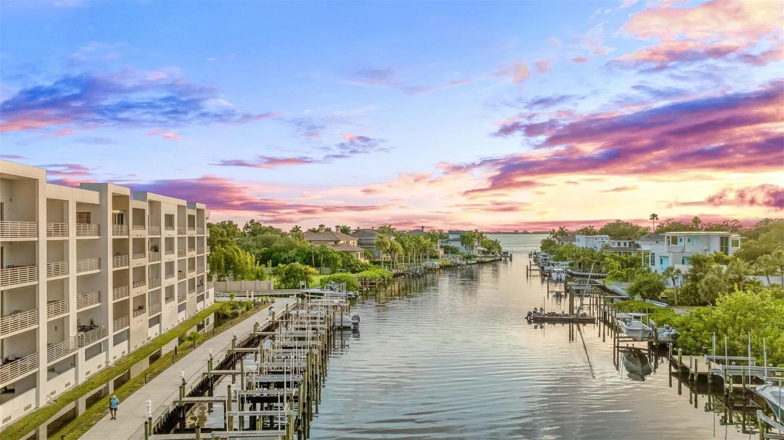 This beautifully finished second-floor condo at The Strand offers a perfect blend of modern comfort and relaxed coastal living just one mile from downtown Sarasota. Built in 2022, this northwest-facing unit features a smart, open layout with a large kitchen island, quartz countertops, and stainless steel appliances, along with a master bedroom and and a kitchen and living room that open up to serene water views. The spacious covered balcony overlooks the canal and is the perfect spot to enjoy colorful Sarasota sunsets. Located in the center section of the waterfront building, this residence offers both privacy and convenience, with no elevator reliance and direct access to the garage level below. The Strand is a gated, amenity-rich community with a resort-style pool and spa, fitness center, kayak and paddleboard launch, BBQ grills, fire pit, dog park, and EV charging stations. One garage parking space and private storage unit are included. Whether you're looking for a full-time residence, a seasonal getaway, or a high-performing weekly rental (min. 7 days, 52x/year allowed), this unit is an exceptional opportunity. Nearby attractions include Whole Foods, the Van Wezel Performing Arts Hall, St. Armands Circle, Lido Beach, and award-winning Siesta Key Beach. Experience easy waterfront living in a newer construction community with top-tier amenities and an unbeatable Sarasota location.