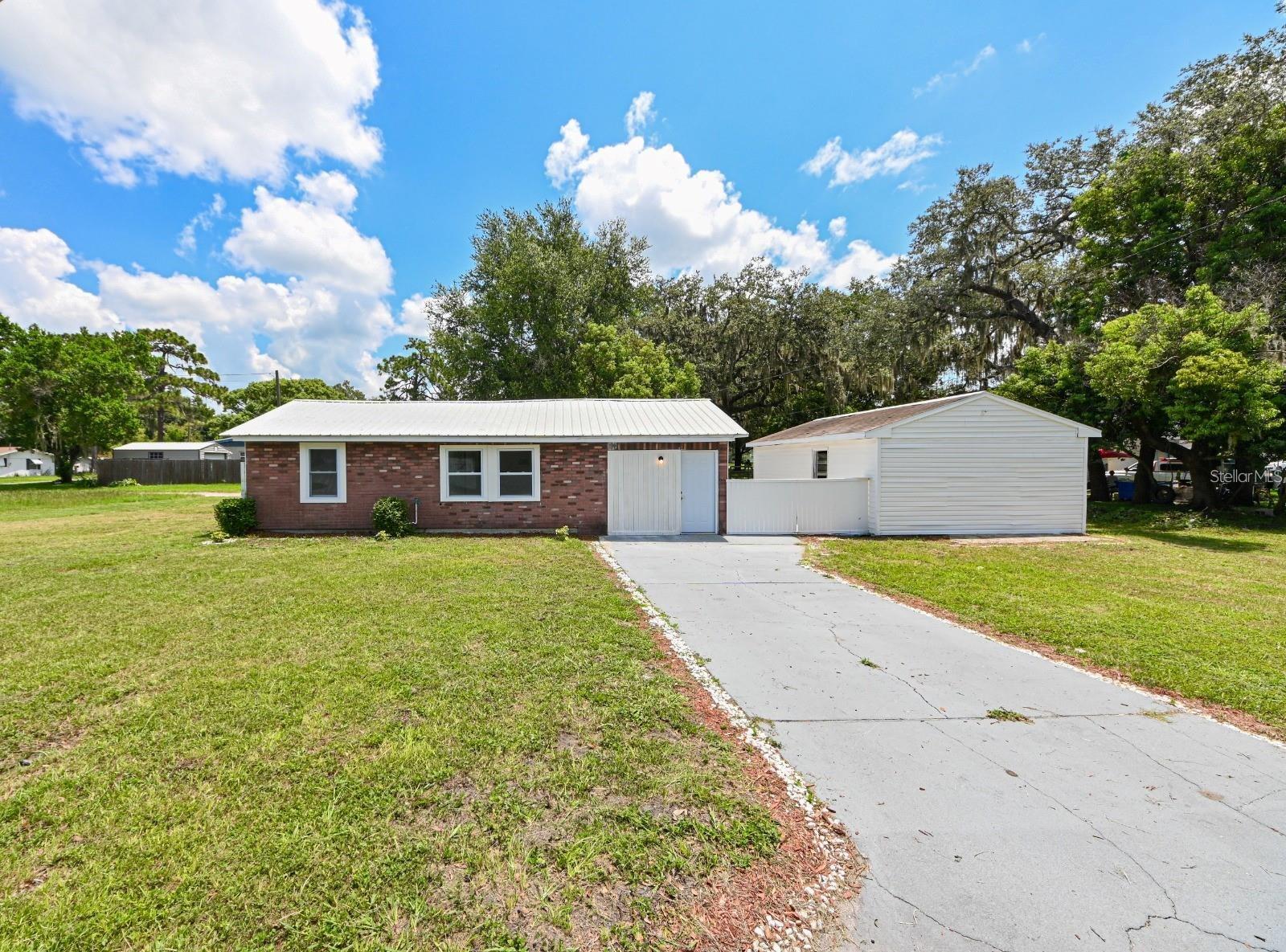 Welcome to this charming, fully renovated home in the heart of Zephyrhills. Situated on a quarter acre of land. Upon entering, you will be greeted by a welcoming open layout, a gourmet, modern, and gorgeous kitchen with high-end stainless steel appliances, recessed lighting and quartz countertop. Plus an attached bonus room, perfect for enjoying meals with family and friends or hosting intimate gatherings. The layout of this home is thoughtfully designed. The added mother-in-law suite/Efficiency offers both versatility and privacy. 5 bedroom, 3 bath masterpiece, meticulously remodeled to perfection, is a true gem, a great opportunity for investors!!!. The exterior of the property features ample space, allowing for possible outdoor activities, gardening, or whatever you desire. This corner home located in a quiet neighborhood is only 1.5 miles away from the vibrant downtown area where you can immerse yourself in the thriving community. Just a 19-minute drive away, you'll find the famous Wiregrass Mall, For convenient travel, the Tampa airport is just 45 minutes away, ensuring seamless connections to the world. With its combination of a beautiful home and proximity to major highways, this incredible opportunity won't be available for long. Don't miss out, schedule a visit now and make this dream home yours.