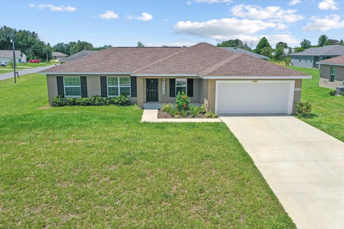 Built in 2023, this 4 bedroom, 2 bath Banyan Model sits on a .30 acre corner lot with a split bedroom layout, a versatile 4th room that can serve as an office or flex space, a built-in in-wall pest defense system, a 2-car garage, and the benefit of no HOA.
The open floor plan features cathedral ceilings, a separate dining area, and a dream kitchen with solid wood soft-close cabinets, granite countertops, stainless steel appliances including refrigerator, and a large eat-at island. Luxury vinyl plank flooring runs throughout with tile in the bathrooms and no carpet.
The primary suite offers tray ceilings, a walk-in closet, and an en-suite bath with a tiled walk-in shower and granite vanity. The guest wing includes three additional bedrooms and a full bath with a tub and shower combo. A spacious laundry room adds convenience and extra storage.
Conveniently located near Publix, shopping, and dining with quick access to I-4 and I-95, this home makes commuting to Orlando or Daytona a breeze. Move-in ready and sitting on a great corner lot, come see it today.
