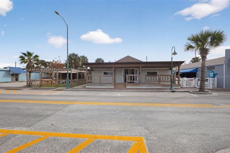 LOCATION — LOCATION — LOCATION. Rare Multi-Use Opportunity on Flagler Avenue Beachside.

Situated directly within the vibrant beachside business district of New Smyrna Beach, this unique multi-building property offers exceptional visibility, flexibility, and investment potential just steps from the ocean, restaurants, and high pedestrian traffic.

The primary building features a beautifully renovated open commercial space with modern finishes, abundant natural light, and a welcoming covered front porch that enhances curb appeal and customer experience. The flexible interior layout is ideal for retail, wellness, office, gallery, restaurant service, or mixed commercial concepts.  

A secondary detached structure provides additional usable space positioned around a private courtyard with turf and deck areas that create a relaxed coastal environment perfect for boutique retail, studio use, tenant occupancy, or experiential activations. The outdoor courtyard serves as a valuable extension of the interior spaces, allowing for seating, events, and enhanced customer engagement.

Recent improvements include extensive interior renovations, including roof replaced in June of 2025, A/C replaced in Feb 2025 and Hot Water Heater replaced in 2025. updated systems, and a turnkey presentation suitable for owner-users, investors, or mixed-use redevelopment. Zoned for multi-use flexibility, the property presents strong opportunities for owner occupancy, rental income, or long-term redevelopment within one of the most desirable commercial corridors in New Smyrna Beach.