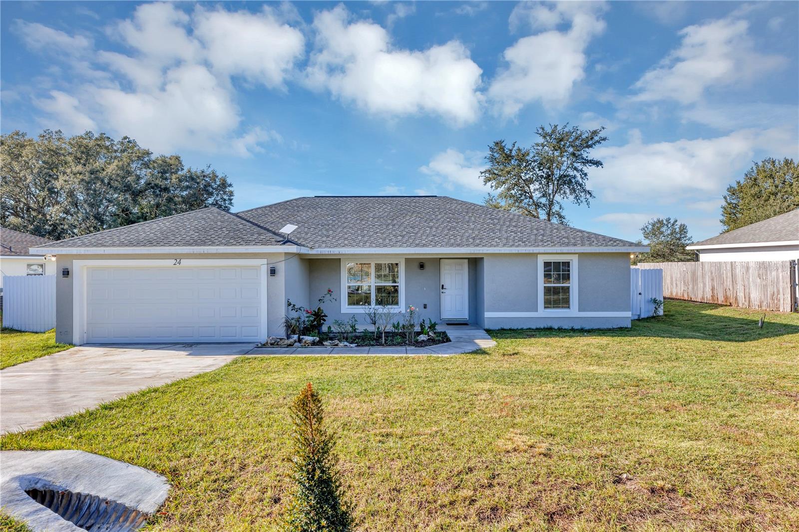 This gorgeous almost new and move-in-ready 3/2/2 home is waiting for you. Newly built in 2023. The home includes stainless steel appliances, luxury vinyl plank flooring, custom kitchen with custom soft close cabinets and quartz counter tops, ceiling fans and inside laundry. This home has Modern light fixtures, quartz counters in all bathrooms, double sink in master with beautiful tile not to mention additional soft close drawers in master bath. The Yard is fully fenced with white metal fencing and plenty of space for entertaining. This home is ready and waiting for you to make it your own!!