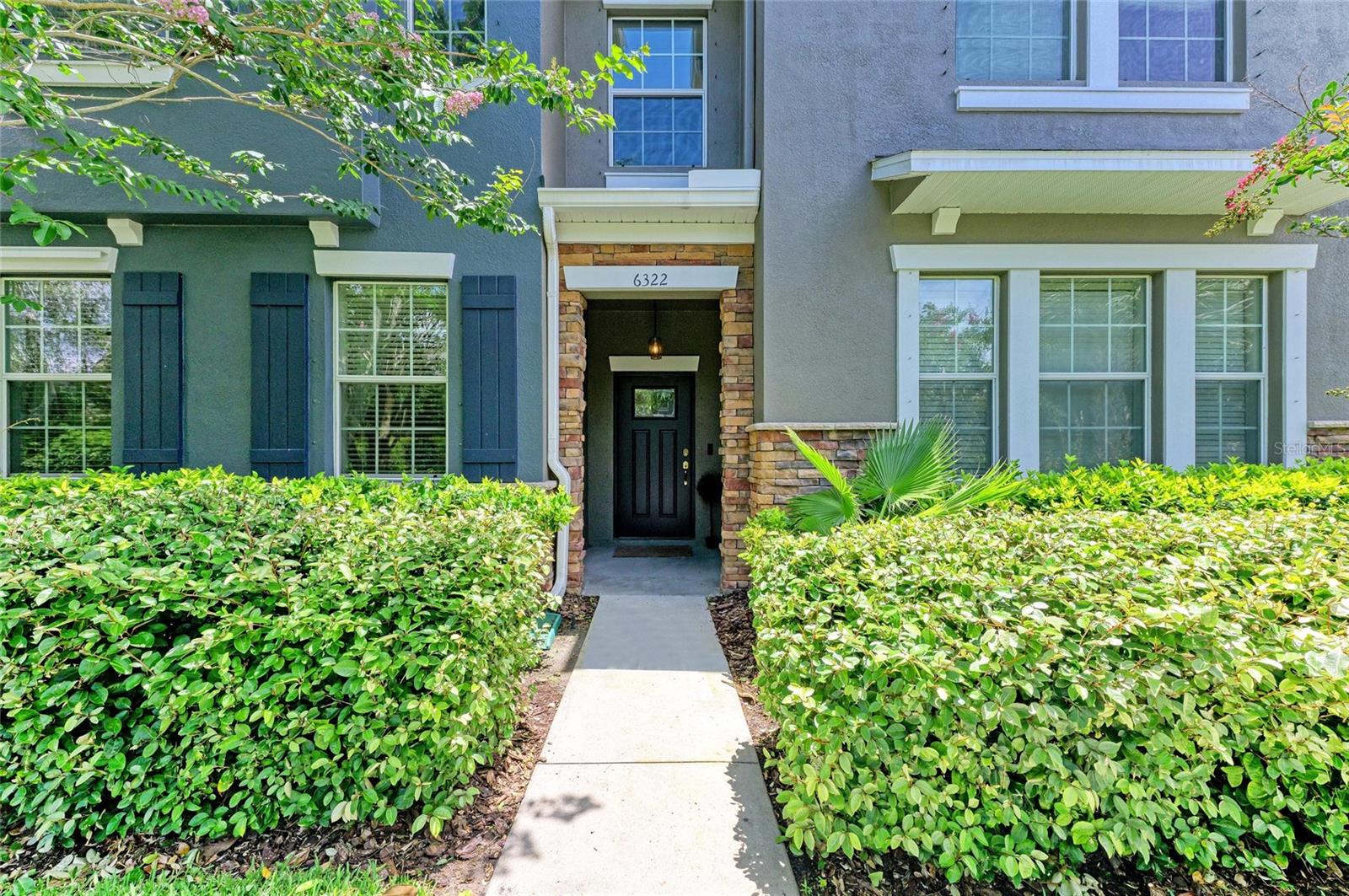 Welcome to 6322 Lantern View Place—a seductive fusion of style, comfort, and resort-level indulgence. This jaw-dropping 4-bed, 3-bath townhome in Apollo Beach’s coveted Waterset community flaunts more than 2,100 square feet of soaring ceilings, designer touches, and a fluid open layout made for modern living. Crown molding graces both levels like fine jewelry, while the gourmet kitchen dazzles with granite counters, stainless appliances (gas range), 42-inch cabinets, and an island begging for cocktails and conversation. A downstairs flex room morphs effortlessly into a chic office or guest haven, but it’s the upstairs primary suite that truly steals the show—showcasing a bold accent wall, custom finishes, massive walkin closet, and a spa-inspired bath where frameless glass and luxe fixtures turn daily routines into rituals. Slide open the doors to your private screened courtyard for sunrise espresso or twilight wine. Beyond your threshold, Waterset spoils residents with three resort pools complete with cabanas and waterslides, a cutting-edge fitness center, courts for tennis and pickleball, dog parks, playgrounds, miles of scenic trails, and a buzzing calendar of food trucks, concerts, and community fiestas. With I-75, downtown Tampa, and Gulf Coast beaches minutes away, this isn’t just a home—it’s a full-throttle lifestyle upgrade.