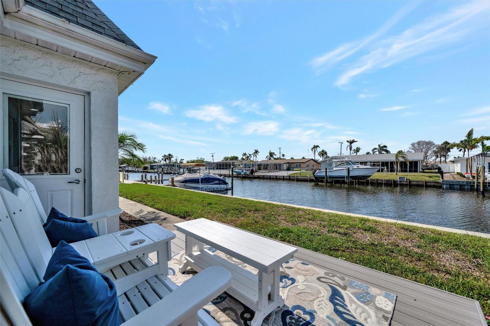 DIRECT WATERFRONT ON THE CANAL!!! Welcome to this cheerfully renovated 2 bedroom, 2 bathroom condo in Casco Dorado, a serene 55+ WATERFRONT/CANAL community in West Bradenton. Just over 2 miles from the white sands of Anna Maria Island, this monthly (2 month minimum) or longer term rental ready home offers the a blend of modern comfort and coastal charm. Perfect for a snowbird or a full time resident, you'll enjoy the convenience of walkable access to nearby restaurants and shopping, along with the tranquil lifestyle of waterfront living. Step inside to an open and bright living space with an impressive 11-foot impact-rated picture window offering peaceful canal views, plus an impact-rated door leading to your private patio with durable composite wood decking. The kitchen shines with quartz countertops, custom wood cabinetry, under-cabinet lighting, and brand-new stainless appliances (2025). Additional updates include a new water heater (2025), all new plumbing and an updated electrical panel (2025), fresh drywall and paint, waterproof luxury vinyl plank flooring, and an in-unit washer and dryer (2025) with a custom storage closet. Both bathrooms have been completely remodeled with new tile, vanities, and toilets. Outside, you’ll find a welcoming front entry deck with composite wood, an outdoor storage closet, and a roof maintained by the HOA, last replaced in 2013. Offered furnished/turnkey. Situated DIRECTLY ON THE CANAL, this home is ideal for boating, fishing, or simply relaxing while watching manatees, dolphins, and mullet. Located minutes from Anna Maria Island’s beaches, shopping, and dining, this cheerful condo delivers the ultimate Florida lifestyle.