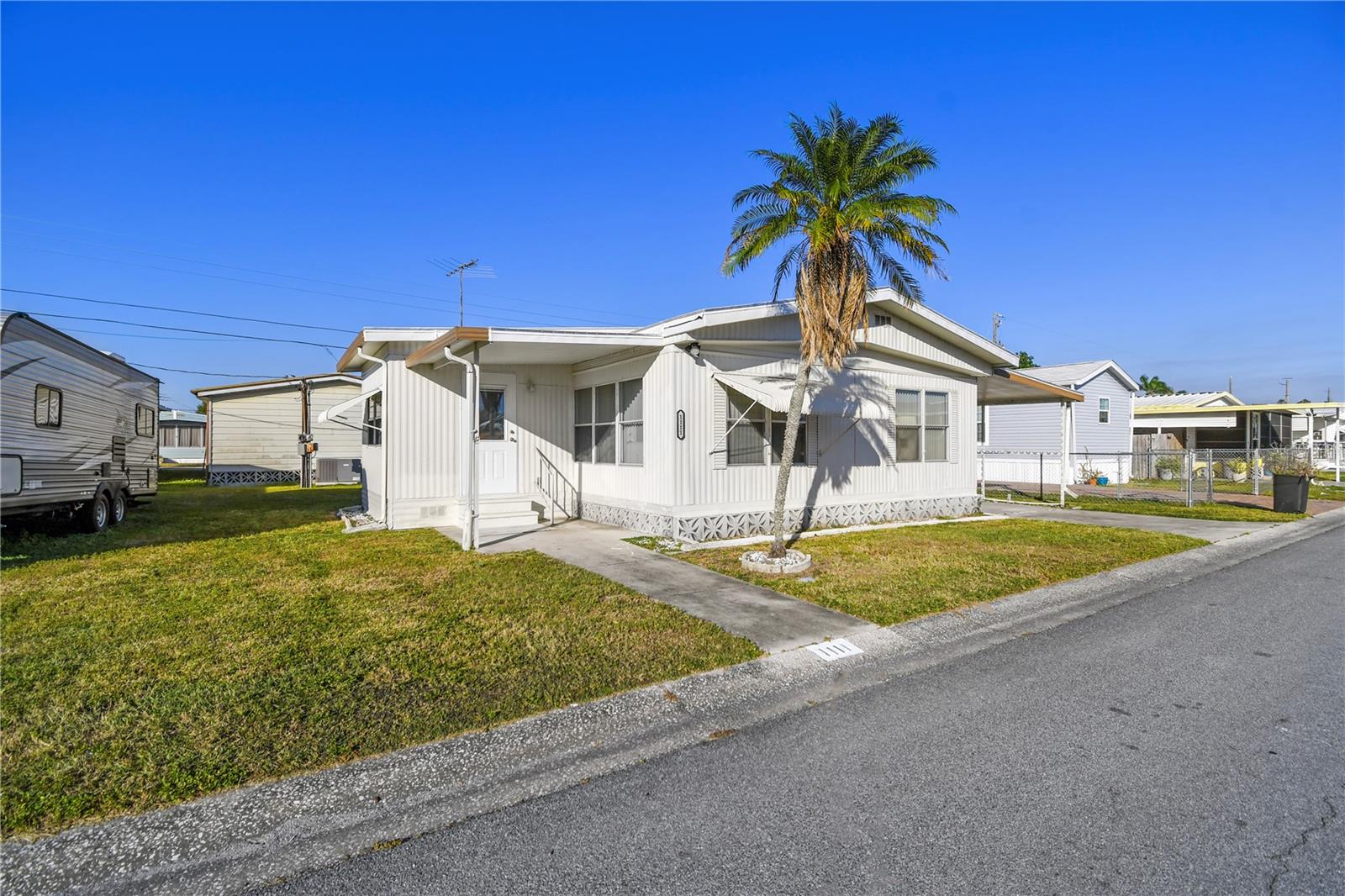 Welcome to Fair Lane Acres, a vibrant and welcoming 55+ community where low-maintenance living meets fun, neighborly charm. This fully furnished 2-bedroom, 2-bath double-wide mobile home is ready for its next chapter. This home is move-in ready with recent updates including fresh paint inside and out, all-new flooring, and a durable TPO re-roof completed in 2022. With a spacious layout, the living room flows into a cozy bonus room, ideal for relaxing, working, or exploring your next hobby. The thoughtfully designed primary bedroom offers comfort and privacy while the second bedroom makes a great space for guests or a shared project area. Enjoy the perks of practicality, too—with a covered carport, a large storage shed with washer and dryer, and, yes, pets are welcome! You’ll own the land, avoid lot fees, and benefit from modest monthly dues that cover water, sewer, and access to fantastic amenities. Fair Acres offers a resort-style lifestyle with a community pool, tennis and pickleball courts, shuffleboard, and regular social activities like bingo, dancing, and community dinners. Want a quiet coffee morning or a chance to show off your moves on the dance floor? This is the place to be. Conveniently located near shopping, dining, and beaches, and just a short drive from the airport, everything you need is within easy reach. This home is being sold as-is—and it won’t last long. Schedule your tour today and see why Fair Lane Acres feels like home!