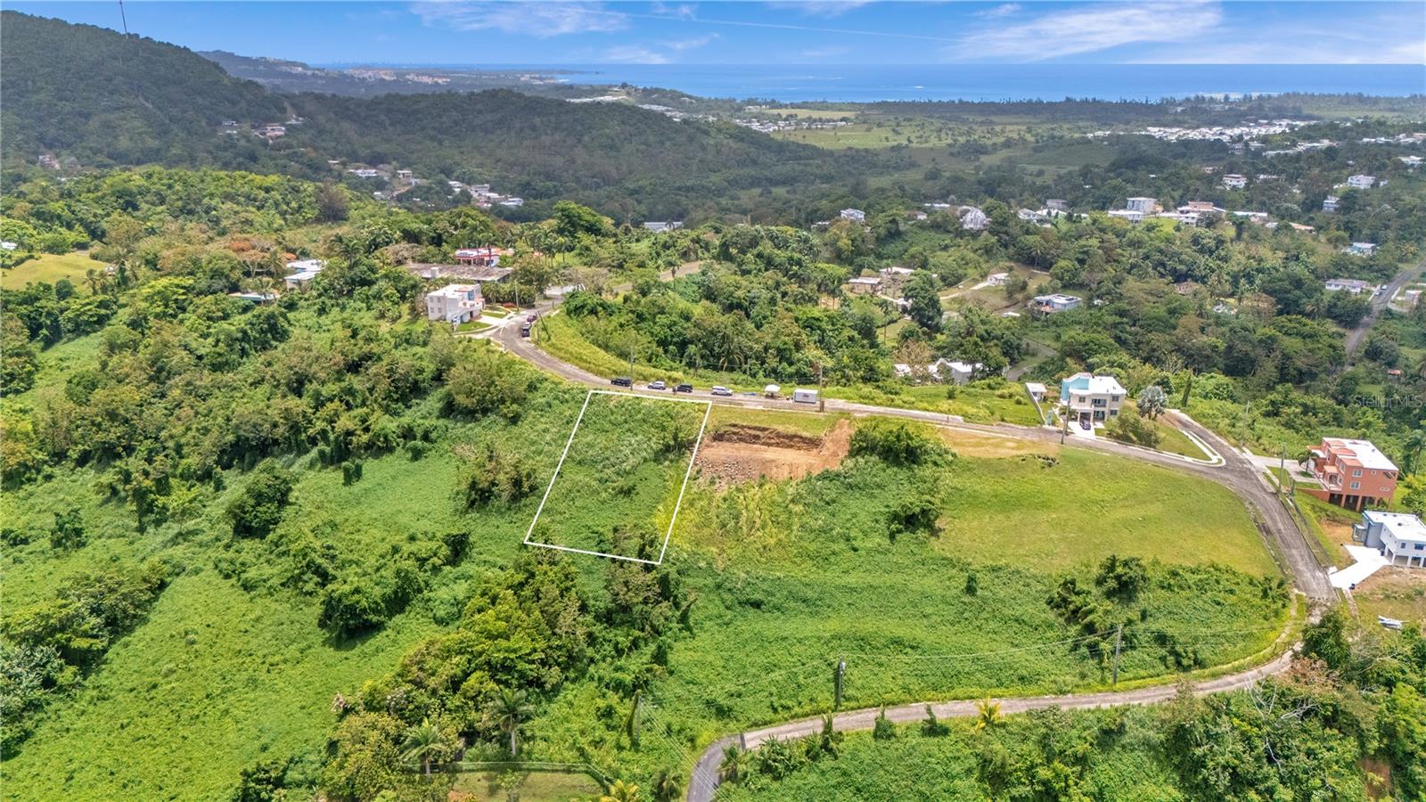 This 1,043 sqm lot in Mansiones de Terralinda, Luquillo sits on elevated terrain with beautiful views, ideal for those looking to build a home surrounded by nature. It is conveniently located just minutes from the beach, tourist attractions, restaurants, and essential services like hospitals and pharmacies. From the property, you can enjoy views of the ocean and El Yunque. Utilities including water, electricity, and sewer are available. MOTIVATED SELLER, schedule your site visit!
