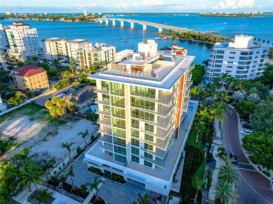 Move-In-Ready, New Construction. Introducing Unit 401 at The Evolution on Golden Gate Point.

Step into unparalleled luxury designed by renowned local architect Mark Sultana, DSDG and furnished by interior design team, Clive Daniels. Unit 401 at The Evolution, where breathtaking westward views of Sarasota Bay greet you every day. Experience mesmerizing sunsets, sailboats gliding across the water, and the twinkling evening lights of the Ringling Bridge—all from the comfort of your home.

Stunning Interior Features:
 • Professionally staged by Clive Daniel Home, blending elegance and comfort.
 • An expansive wrap-around deck offers panoramic views of Sarasota Bay and downtown Sarasota, creating the perfect setting for relaxation or entertaining.
 • The open-concept living space features a dry bar with two Sub-Zero wine refrigerators, an electric fireplace, and beautiful porcelain tile flooring throughout.
 • The chef’s kitchen boasts upgraded Italian cabinetry and a premium water filtration system providing instant hot, cold, and carbonated water.
 • A large den with elegant French glass doors offers flexibility as an office, media room, or additional guest space.
 • The entire home is fully wired for future electronic shades, offering convenience and modern luxury at your fingertips.

Luxurious Private Retreats:
 • This spacious 2,505 sq ft residence features 3 bedrooms and 3 bathrooms, designed to live like a single-family home.
 • Two of the bedrooms are ensuite, including the lavish primary suite with sweeping views of Sarasota Bay and Golden Gate Point.
 • The primary spa bathroom is a sanctuary, featuring a freestanding porcelain soaking tub, dual vanities, and refined finishes.
 • The private balcony off the primary bedroom invites peaceful mornings and serene evenings overlooking the water.

Exclusive Lifestyle & Amenities:
 • Includes a private deeded 2-car garage, offering added convenience and security—a rare feature in luxury condo living.
 • The Evolution offers boutique luxury living with only 20 exclusive residences.
 • Indulge in the rooftop oasis with panoramic bay views, a spa, outdoor lounge with a fireplace, and sunsets stretching to the Gulf of Mexico.
 • The amenities floor includes an outdoor kitchen poolside, a yoga room, fitness center, imported sauna, and a stylish club room—all designed for relaxation and entertainment.
 • Enjoy the convenience of a full-time concierge service and secure access throughout the building.

Unmatched Sarasota Lifestyle:
 • Perfectly positioned in the heart of Sarasota, The Evolution offers walkable access to downtown dining, art galleries, theaters, and the vibrant energy of the city.
 • Just minutes from St. Armands Circle, Lido Beach, and Sarasota’s renowned cultural attractions, you’ll experience the best of the city and the tranquility of waterfront living.

Unit 401 is more than a residence—it’s your gateway to the vibrant Sarasota lifestyle, where luxury meets convenience and every day feels like a getaway.