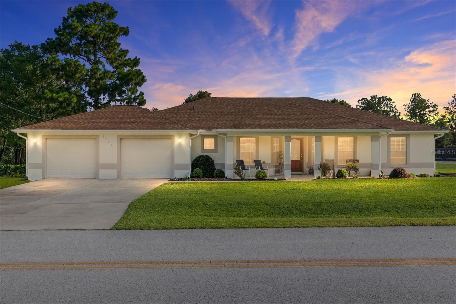 Ideal Location & Impeccably Maintained home. Welcome to this beautifully cared-for 3-bedroom, 2-bath block home in a golf cart-friendly community just across from The Villages – with no HOA and pride of original ownership evident throughout! Situated on a landscaped corner lot, this home offers both convenience and comfort in a sought-after Summerfield location. Step inside to find vaulted ceilings and natural light filling the space. The entry foyer opens to a formal dining room on one side and a private office with French doors on the other. The engineered hardwood flooring flows through the main living areas, with carpeted bedrooms in a desirable split-bedroom layout. The spacious living room features sliding doors that lead to a covered lanai, perfect for morning coffee or evening relaxation. The fully equipped kitchen boasts granite countertops, stainless steel appliances, a pantry closet, and a casual dining nook for everyday meals. The primary suite offers a large walk-in closet and an ensuite bathroom with a dual granite vanity, garden tub, and roll-in shower. A privacy door separates the guest wing, which includes two additional bedrooms and a full bath with granite counters. Practical features include a laundry room with extra project or storage space, and a generously sized 28' x 24' garage with room for two cars plus a golf cart. Enjoy relaxing on the covered front porch and appreciate the curb appeal of tasteful landscaping. This is a rare opportunity to enjoy peaceful living with easy access to all the shopping and entertainment of The Villages—without the fees.