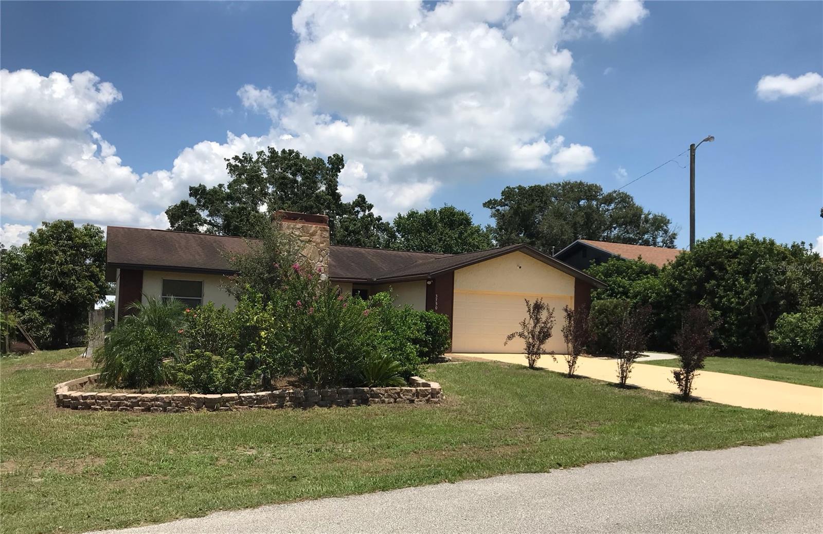 BANK OWNED PROPERTY ready for a new owner. This home features a stone fireplace in the living room, en-suite master bath and two additonal good sized bedrooms. Lots of storage witih two large sheds with the 15X24 shed having electricity which owuld make a perfect man-cave or she-shed. Conveniently located to US98 and quick access to areas amenities including Orlando.