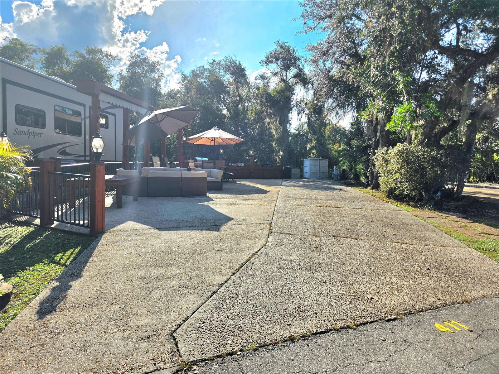 Welcome to your own slice of paradise at the exclusive River Ranch RV Resort – one of Central Florida’s most sought-after luxury RV destinations. This turnkey RV lot, located in Phase 4, is just steps away from resort amenities including the pool, restrooms, showers, and laundry facilities – offering both convenience and comfort.
Outdoor "Camping" at Its Best:
This beautifully upgraded lot features a fully equipped outdoor kitchen, complete with a grill, and outdoor dining table – ideal for entertaining or unwinding under the stars. The lot is thoughtfully furnished with comfortable seating, plentiful outdoor furniture, and large umbrellas for shade, making it the perfect retreat year-round.
Private Setting: Enjoy peaceful views with no rear neighbors, offering added privacy and a serene atmosphere surrounded by lush landscaping.
Prime Location:  Just around the corner, indulge in all the fun and excitement at Westgate River Ranch Resort, where you'll find on-site restaurants, adventure activities, a water park, and more (additional fees apply). As a River Ranch RV Resort owner, you’ll benefit from exclusive discounts at Westgate's dining venues and water park.
Whether you're looking for a weekend escape, seasonal getaway, or income-generating investment, 411 Longhorn Drive is your opportunity to own in a community where luxury meets outdoor lifestyle.