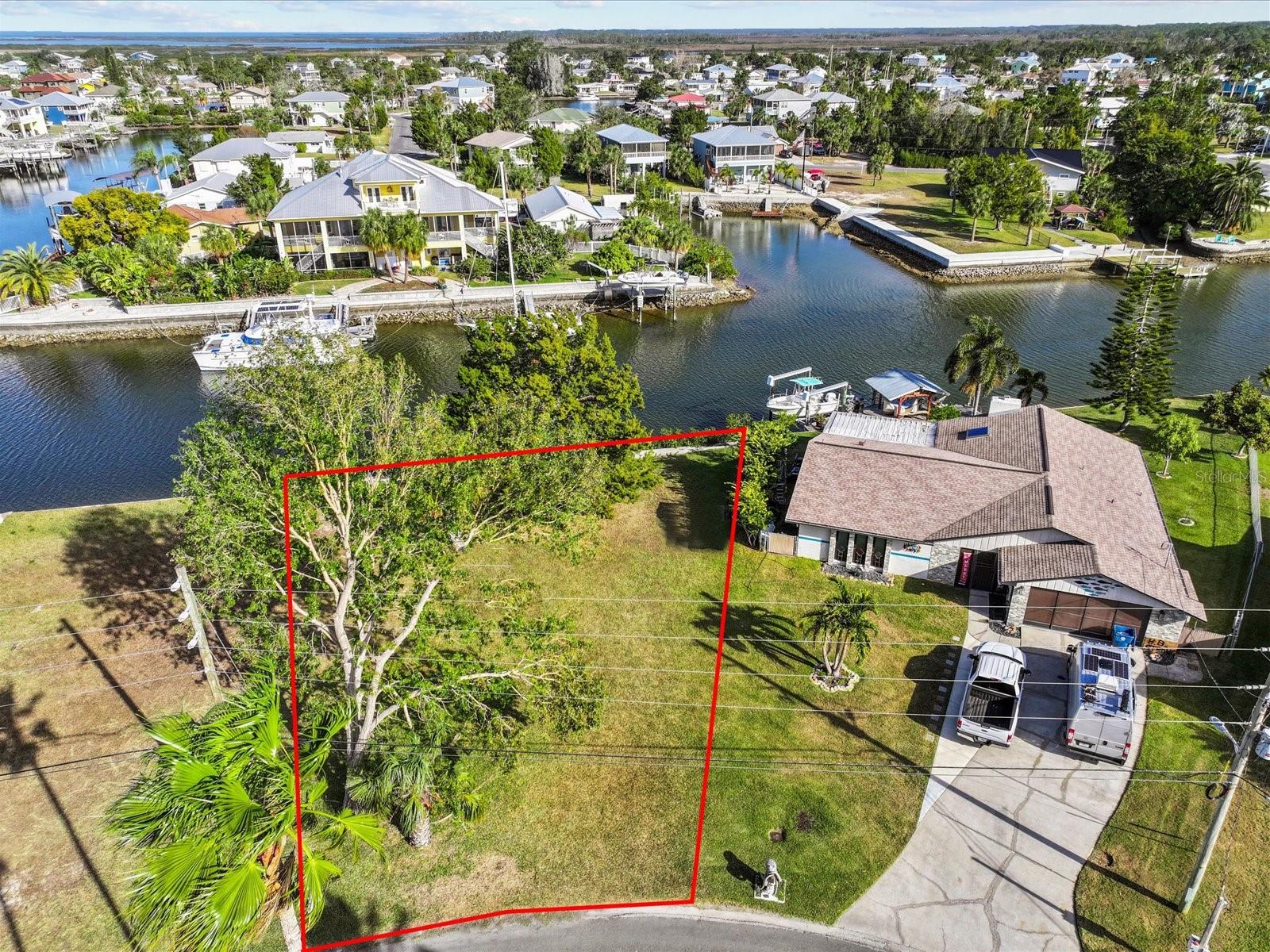 Welcome to a rare opportunity to own a piece of paradise in Hernando Beach, nestled along Florida’s stunning Gulf Coast. This exceptional lot boasts 90 feet of prime waterfront on a saltwater canal with a concrete seawall with overcap and a floating dock, providing direct access to the Gulf of Mexico without any fixed bridges. Imagine waking up to dolphins and manatees frolicking in your backyard, while you cast your line for redfish, snook, and snapper right from your own property.
Located in the coveted Direct Access section of Hernando Beach, this property offers unparalleled boating convenience. The saltwater canals ebb and flow with the tides, enhancing your waterfront experience daily. Importantly, this section operates without an HOA, offering freedom from deed restrictions—allowing you to store boats, trailers, and commercial vehicles on your property, erect 8-foot-high privacy fences, and even use your home as a short-term rental.
Hernando Beach itself is a hidden gem, where the community thrives on recreational fishing and boating. Despite its serene coastal feel, amenities such as marinas, waterfront dining, and shops are easily accessible. The area is renowned for its thriving commercial seafood industry and world-class fishing opportunities, whether you prefer inshore fishing along the mangrove coastline or venturing offshore for deep-sea adventures.
In addition to its natural beauty and vibrant community, Hernando Beach offers surprising convenience. Just minutes from US 19, residents have quick access to supermarkets, restaurants, and major hospitals. Tampa International Airport is only an hour away, and the magic of Disney is within a 90-minute drive—perfect for a spontaneous getaway.
This lot presents the perfect canvas for your Gulf Coast dream home—a tranquil retreat where coastal living meets unmatched convenience. Whether you’re seeking a permanent residence or a vacation escape, Hernando Beach promises a lifestyle defined by breathtaking sunsets, endless fishing adventures, and the soothing rhythms of Gulf Coast living.
Don’t miss out on this opportunity to build your own slice of paradise in Hernando Beach. Schedule a viewing and begin your journey towards owning a waterfront oasis on Florida’s enchanting Gulf Coast.