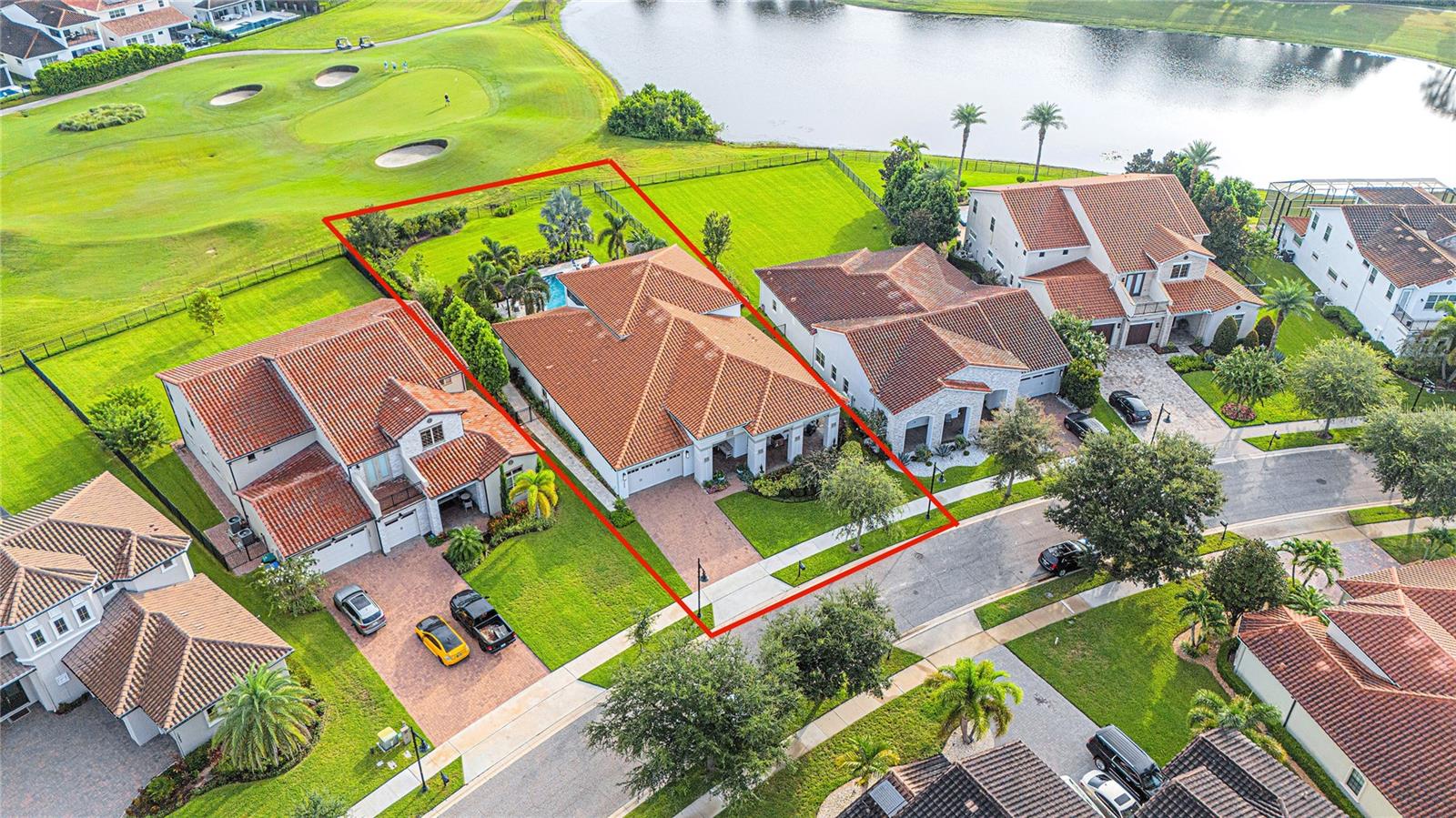 Welcome to your private sanctuary, where a championship golf course provides a picturesque backdrop, and serene water views offer a daily dose of tranquility. Located in the guard-gated golf community of Eagle Creek in Lake Nona, this 4,500 square foot home is centered around a magnificently curated outdoor oasis that truly sets this property apart. A sparkling pool invites you to relax on sunny afternoons, and the custom-built pergola with a stunning waterfall feature creates a shaded retreat while enjoying the sound of flowing water. For quiet reflection, the expansive upstairs balcony provides panoramic views of the fairway and water and also captures breathtaking sunrises and sunsets. The outdoor amenities cater to every lifestyle. The built-in beverage center makes hosting gatherings a breeze, whether you're serving drinks poolside or enjoying a casual Florida evening. For the culinary enthusiast, a dedicated edible garden offers fresh herbs and produce right at your fingertips, a true farm-to-table experience. Your furry friends will also feel right at home in their secure, private dog run, ensuring a safe space for play and exercise. The interior is bathed in natural light, showcasing refined finishes and an open-concept layout built for both grand entertaining and intimate family times. From the moment you step inside the house, the expansive doors and windows frame the breathtaking scenery, creating a seamless connection to the outdoors. This home has plenty of room for everyone – offering 4 bedrooms, 5 full bathrooms, a private office, formal dining room with adjacent butler’s pantry, built-in drop zone at the garage entryway, upstairs bonus room with built-in beverage center, and a three-car tandem garage. The first-floor primary suite includes a custom luxury closet that functions as a dressing room and is conveniently adjoined to the laundry room. The primary bath provides a spa-like experience, boasting a large walk-in shower, double vanities, private water closet, and a deep soaking tub for a serene escape from your busy day. The gourmet kitchen with modern amenities is anchored by a spacious and functional island with dedicated seating, allowing for casual dining, socializing and gathering in the kitchen. Other notable features of this home include a Kinetico 5 stage whole house water filtration system with reverse osmosis at the kitchen sink, Phantom retractable screens on both lower and upper lanais, and a fully fenced-in backyard. Whether you're hosting a party, enjoying the tranquility of your surroundings, or spending time with family, this home provides a captivating and functional setting for every occasion. Eagle Creek is a master-planned, guard-gated community in the Lake Nona area of Orlando, known for its championship golf course and resort-style amenities. Residents can enjoy community pools, a fitness center, tennis and basketball courts, a dog park, multiple playgrounds, and a clubhouse with a restaurant and bar.