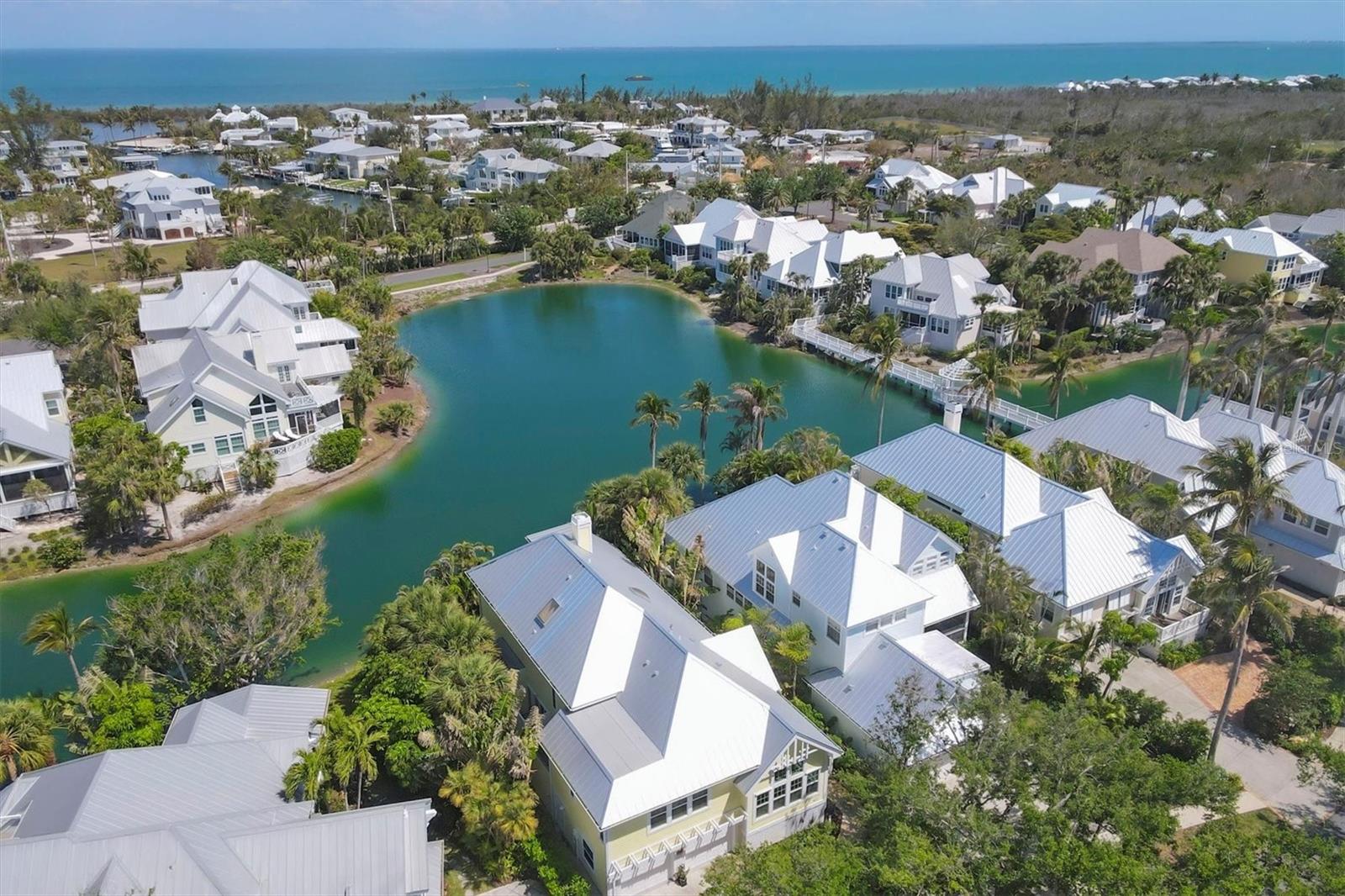 Nestled in the exclusive gated community of Boca Bay's North Village, this stunning 3-bedroom, 3-bathroom home offers over 3,200 square feet of beautifully updated living space with breathtaking lake views. Thoughtfully designed with high-end finishes and modern upgrades, this home is perfect for those seeking both luxury and comfort. The renovated chef’s kitchen is a showpiece, featuring quartz countertops, a shiplap ceiling, Thermador appliances (oven, microwave, and gas stove), a WiFi-enabled Monogram refrigerator, and a built-in ice machine. An eat-in dining area provides a warm and inviting space. The living room impresses with vaulted ceilings, an eye-catching fireplace, and a built-in bar, all enhanced by Sonos surround sound throughout, creating an ideal setting for entertaining or unwinding. Hurricane-impact windows and doors, a newer standing seam metal roof, and plantation shutters throughout provide both elegance and peace of mind. The primary suite is a private retreat, featuring French oak engineered wood flooring, a spacious loft/living area with a private office, and a spa-inspired bathroom with a copper tub and sophisticated accents. Each bathroom has been beautifully updated, adding to the home’s refined feel. Designed for seamless indoor-outdoor living, the expansive lanai offers breathtaking lake views, making it the perfect place to enjoy your morning coffee or entertain guests. A private outdoor shower adds a touch of island charm, while a Zen garden off the dining room enhances the home’s peaceful ambiance. As a resident of Boca Bay, you’ll have access to exclusive world-class amenities, including a private boat basin with slips, a croquet sports field, Har-Tru tennis courts, and four swimming pools, including a lap pool. The Gulf-front Beach Club offers a premier venue for private events, while the community fishing pier provides a serene waterfront escape. Additionally, members have access to the prestigious Pass Club, featuring exceptional dining and social opportunities in an unparalleled waterfront setting. This is a rare opportunity to own a luxurious lakefront home in one of Boca Grande’s most coveted communities. Schedule your private showing today!