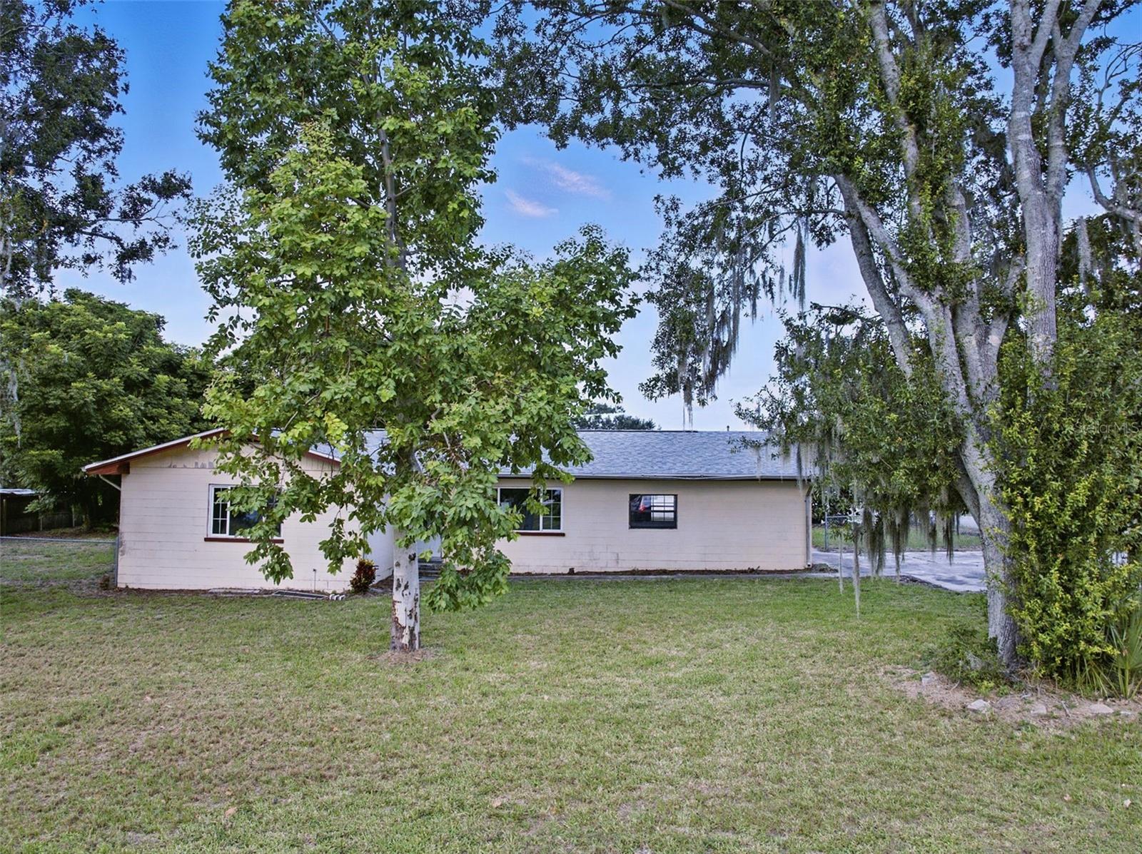 One or more photo(s) has been virtually staged. Charming Home with Lake Clinch Views!
This spacious 3-bedroom, 2-bath home offers a large living room, a separate family room, and a kitchen with abundant cabinet storage that opens to the dining area. Enjoy outdoor living with a large screened-in patio, a fenced yard, and two storage sheds for all your needs. Situated on a desirable corner lot, this property has excellent potential to be transformed into your ideal living space.
This home is being sold AS-IS—don’t miss your chance to make it yours. Schedule your private showing today before it’s SOLD!