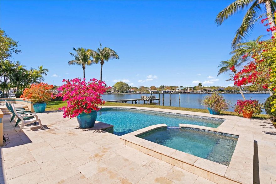 Take a look at this cherished Snell Isle waterfront home, offered for sale for only the second time since 1952. Situated in a prime location, this residence offers abundant living space and a backyard oasis.  The pool glistens in the large, sunny backyard where dolphin and manatee are seen daily.   With four bedrooms and three baths, this meticulously maintained home seamlessly blends vintage charm with modern comfort. Highlights include the newer kitchen open to informal living/dining space, separate formal living and dining areas, a large, covered patio off the downstairs living space, an indoor laundry room with ample storage, an office or fourth bedroom on the first floor, and a private courtyard entry. French doors and tall windows downstairs, along with a large deck off the primary suite, allow for generous views of the water from almost every part of the house. One look at this home, and you will understand why St. Pete was voted one of the 15 happiest places to live in the U.S. The vibrant downtown waterfront, Central Avenue shops and restaurants, world-famous art museums, and white sandy beaches are minutes away by bike, car, or boat.