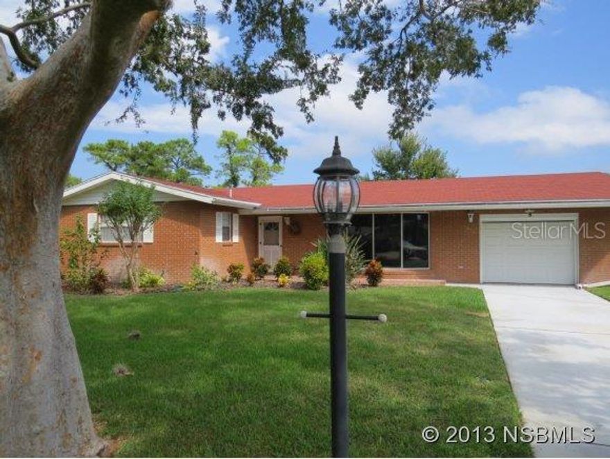 GOLF FRONT LIVING - Enjoy panoramic views of the fairways, and bring your golf cart - spacious garage has golf cart parking pad with roll-up door and concrete ramp leading to back yard and on to bridge accessing fairways of municipal golf course. Brick home has roomy living room with bay window, nice dining area and separate family room off of kitchen. Enclosed porch out back to enjoy the views. Great central location, just a few minutes to shopping, dining, entertainment and the beach. Enjoy living in a golf community, but no home owner dues or regs. Surrounded by 2 golf courses open to the public - Hidden Lakes golf course offers large pool by membership or short term use. Gas stove was added by previous owner, but can be switched back from propane to electric. Rear yard fence is installed well-within property line of large lot, specially at rear yard. Property offered unfurnished, but furnishings available outside closing by inventory, and negotiable. ;Water: City