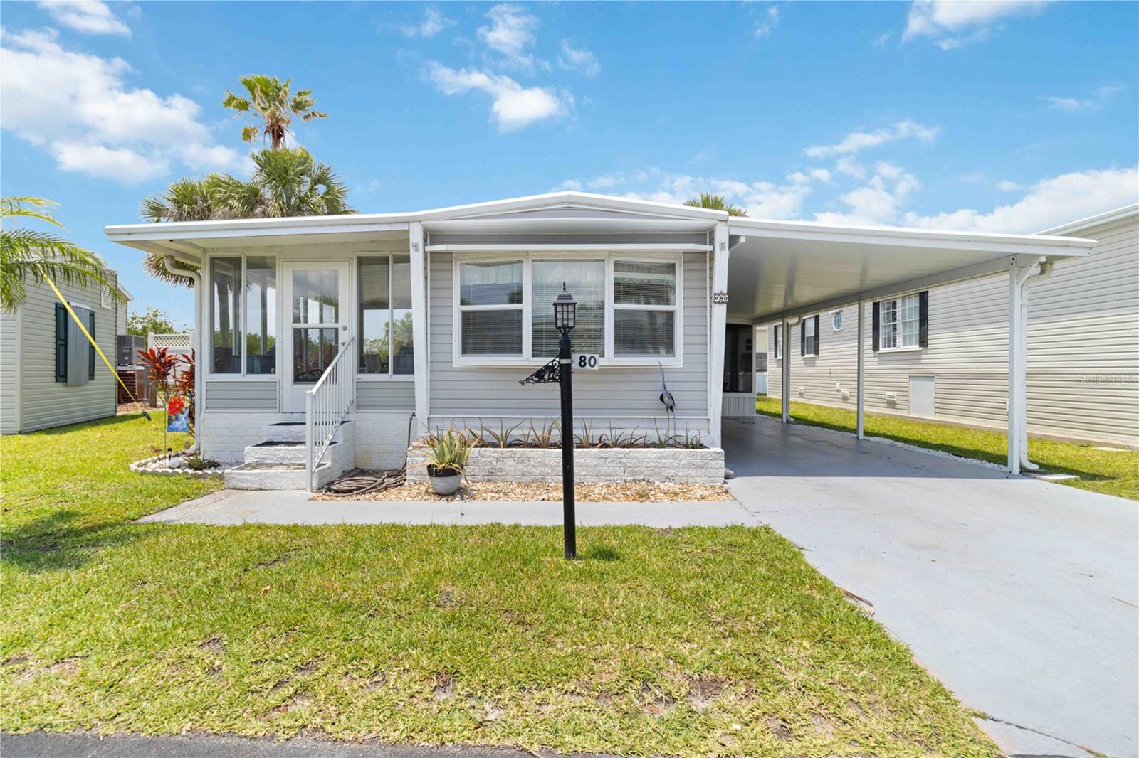 Step into the epitome of coastal charm and comfort with this completely renovated, turnkey 674-square-foot 1973 manufactured home, nestled in the desirable 55+ waterfront community of Eagle Point in Punta Gorda, Florida. Every detail of this singlewide has been thoughtfully updated, from the waterproof laminate flooring that flows throughout to the soft-close cabinetry and gleaming new stainless-steel appliances in the stylish kitchen—complete with a central island for added storage and seating. The spacious primary bedroom offers ample closet space, while the beautifully remodeled bathroom features a sleek walk-in shower.
Enjoy the seamless flow of the open-concept great room into the Florida room, where peaceful views of mangroves and the lake create a serene backdrop for relaxing or entertaining. This home has been upgraded with a brand-new AC in 2024, a roof just eight years young with a lifetime warranty, a newer water heater (2021), and a refreshed vapor barrier with sprayed-in foam insulation for year-round comfort.
Located within a resident-owned co-op, ownership requires a minimum of five shares ($1,000 each), with the option to purchase up to 20 shares—offering flexibility and potential for lower HOA fees. Eagle Point is a pet-friendly community that welcomes two pets up to 30 lbs. Residents enjoy a vibrant lifestyle with amenities including a heated community pool, scenic pond, shuffleboard courts, boat storage, and regular community events. Just a short drive from historic downtown Punta Gorda, with its renowned dining, boutique shopping, entertainment, and golf, this location also offers easy access to I-75 for quick trips north to Sarasota/Tampa or south to Fort Myers.
Don’t miss your chance to own a piece of paradise—schedule your private showing today.