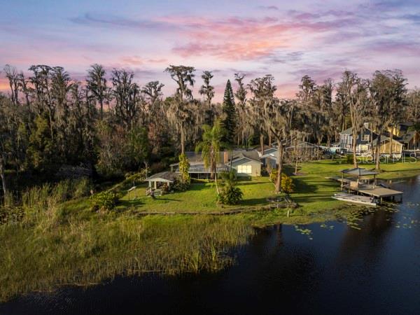 Welcome to your private Lakeside Oasis! Nestled on the shores of the picturesque Lake Allen in Lutz. This charming ranch style home is 3 bedrooms and 1 bath. Conveniently located close to shopping, restaurants & medical facilities yet as you drive in you will enjoy the tranquility of the natural Florida setting. Situated on a 1/3-acre lot, this property boasts breathtaking views and direct access to the pristine waters of Lake Allen, a 24-acre private ski lake. This home offers 2,077 heated square feet with a double brick fireplace in the family room and living room areas with beautiful white terrazzo floors throughout many of the living spaces. Whether you are looking for a weekend getaway or a year-round residence this lake front property will not disappoint. This home would be a great fixer upper, tear down or rebuild as much of the value is in the lakefront land. There are plans drawn up for the home to be redeveloped & made larger. Please ask Realtor for a copy of those. Call today to find out more about this beautiful property.