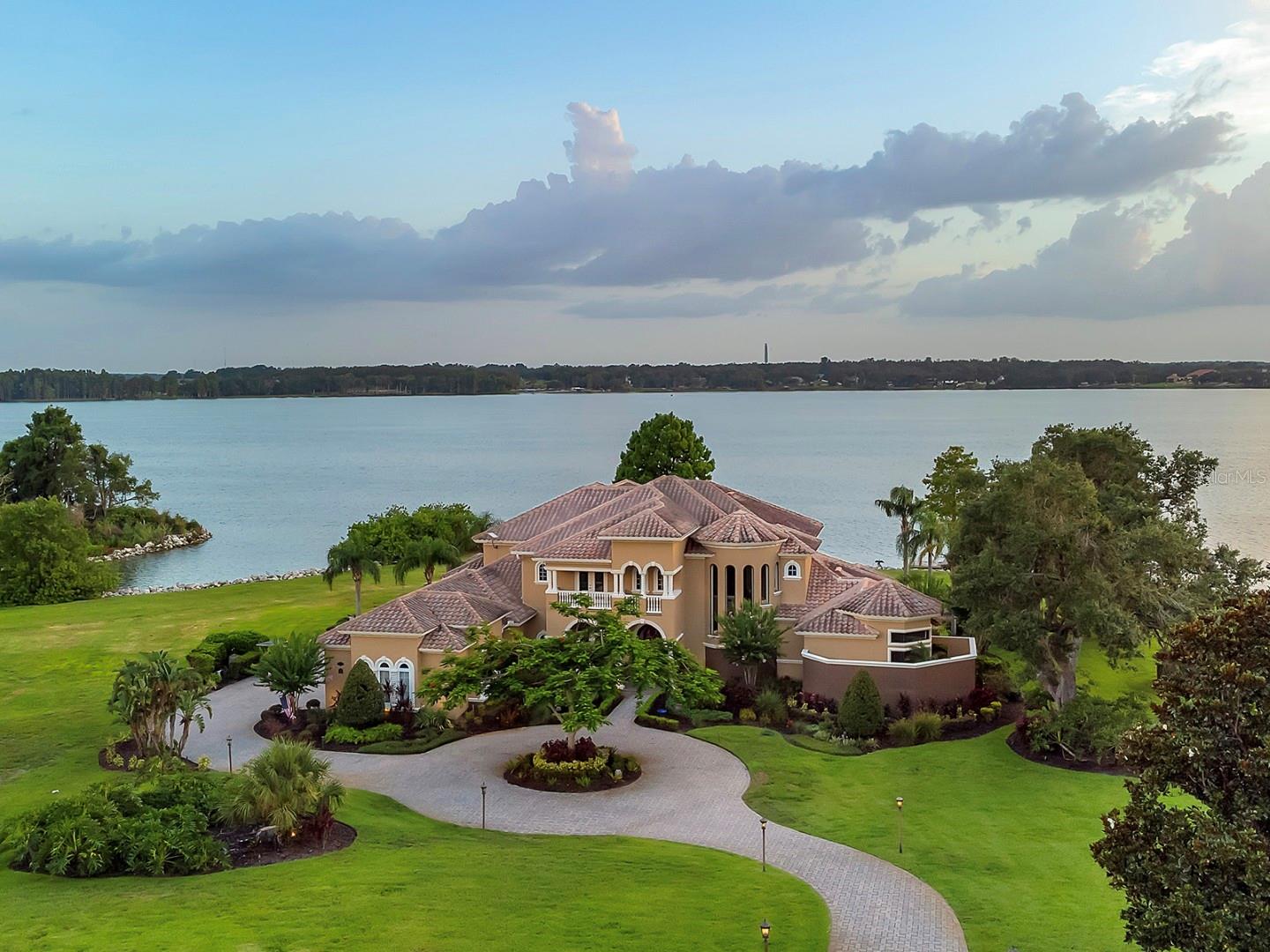Welcome to 12125 Stonelake Ranch Blvd., a luxurious lakefront estate where elegance meets resort-style living. Located in the exclusive, gated community of Stonelake Ranch on the shores of Lake Thonotosassa, this custom-designed residence boasts over 7,000 sq ft of living space, offering 5 spacious bedrooms, 5+ bathrooms, and an unmatched collection of luxury amenities. The kitchen, with its high-end appliances, will be the envy of any gourmet chef. The large primary wing features a large bedroom with its own sitting area with plenty of room for relaxing and taking in the beautiful views of the pool and the lake in the back, with plenty of closet space and magnificent tub and shower areas. You can enjoy a private full-size home gym, relaxing sauna, billiards and game room, and your own climate-controlled wine cellar. A private elevator ensures convenience across all levels of the home, while expansive living areas and soaring ceilings create a grand yet comfortable feel. Designed for entertaining and everyday luxury, the home features high-end finishes, stunning architectural details, and breathtaking views. The oversized lot offers both privacy and access to the lake, making it a rare find in one of Tampa Bay's most prestigious communities.
About Stonelake Ranch: Stonelake Ranch offers over 10,000 feet of waterfront property along the eastern shores of 880-acre Lake Thonotosassa. This Tampa lakefront community offers an abundance of activities and amenities sure to please even the most discerning of tastes. Here you will find the finest in Tampa lakefront living, with lakefront and lake view home sites, private docks and boating access. This private countryside is a world away from city life, yet a mere 20 minutes east of metropolitan Tampa. Towering stands of oak, magnolia, hickory, citrus and palm trees populate densely wooded areas, while open fields, diverse woodlands, winding creeks, and an island avian sanctuary provide refuge to native birdlife like ibis and spoonbills. For the boating or fishing enthusiast, Lake Thonotosassa is a secluded sporting ground with very limited public access. There will be days that you will have the lake all to yourself. For those who prefer to enjoy their free time on land walking, jogging, biking or horse-riding, Stonelake Ranch boasts 240 lush acres of common area and an extensive trail system that winds throughout the community. No matter where you roam on the pristine acreage of Stonelake Ranch there will be wide open spaces and awe inspiring views. And with only 160 home sites, spread over 685 acres, you are sure to always feel a sense of privacy and tranquility in this unique Tampa lakefront community surrounded by cool waters and endless sky. Convenient access to I-75 and I-4 make traveling in any direction easy. Live the lifestyle you've earned! This is Stonelake Ranch. Call today to schedule your private tour of this magnificent home!