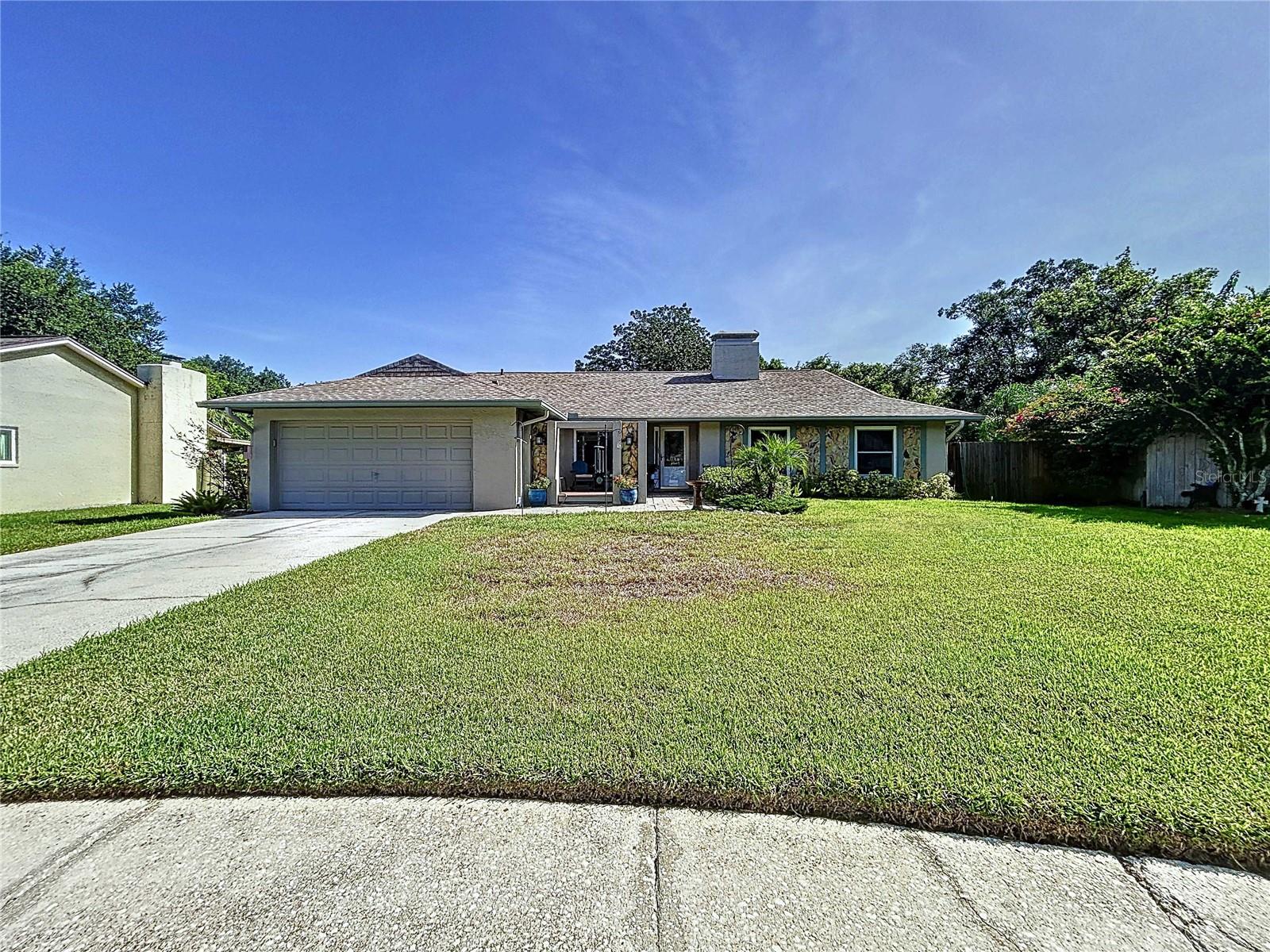 If a country setting with city conveniences is what you desire, this Charming, move-in ready, one level Single Family Pool Home is a must see! This 4 bedroom, 2 bath home is situated on a beautiful .26 acre premium cul-de-sac home site in the quiet, highly desirable Tampa/Carrollwood community of Country Place; an idyllic, Low-HOA, non-CDD community conveniently positioned near shopping, restaurants & major interstates. The easy and natural flow of this charming Westbrook built, Monarch floor plan makes the spaciousness of this 1,815 square foot casual yet elegant home feels even grander. The interior boasts an open floor plan, a nice sized family room measuring approximately 14X19 with a wood burning fireplace and sliding doors that exit to the lanai, high ceilings, split bedroom plan, formal living room, formal dining area, skylights, inside laundry room w/large custom cabinets & laundry sink, front entry door w/stained glass allowing ample natural light, window blinds, a warm color pallet, whole house water filtration system, neutral tile in wet areas & luxury vinyl wood flooring flow throughout the home. The kitchen has ample cabinet and counter space, Quartz countertops, tile backsplash, brushed nickel cabinet hardware, breakfast bar, large walk-in pantry, reverse osmosis system & stainless appliances. The primary bedroom is 13x17, with a large walk in closet. The en suite bath has double bowl vanity w/granite countertop, upgraded light fixture & faucets & step in XL shower w/earth tone tile. The 2 car garage also includes several desirable upgrades such as an upgraded garage door for storm protection, epoxy floors and a 240V outlet for EV charging. The natural foliage, vegetation and mature trees provide a peaceful backdrop for your private in ground pool; the covered & screened lanai with ample under roof seating space overlooking the pool offers the perfect setting for family gatherings, entertaining or to simply relax. Don't be fooled by this rural setting as it is conveniently located just minutes from everything you may need. No CDD Fee and a Low HOA fee of $150 per year make this community even more desirable! This awesome home offers a plethora of upgrades, to follow are just a few: Roof 2021 with transferable warranty, HVAC 2019, Double Pane Windows, Hurricane Aluminum Window Panels, Upgraded Garage Door (storm protected), Updated Kitchen, New Flattop Electric Range 2024, Updated Bathrooms, Newly Replaced Interior Doors, Luxury Vinyl Plank Flooring, Energy Efficient Pool Pump, Epoxy Garage Floor & 240 Volt Outlet for EV Charging. ***Buyer of this home will receive a 1% Lender Credit with the use of Jeffrey McCarthy, Mortgage Advisor with NEXA Mortgage**