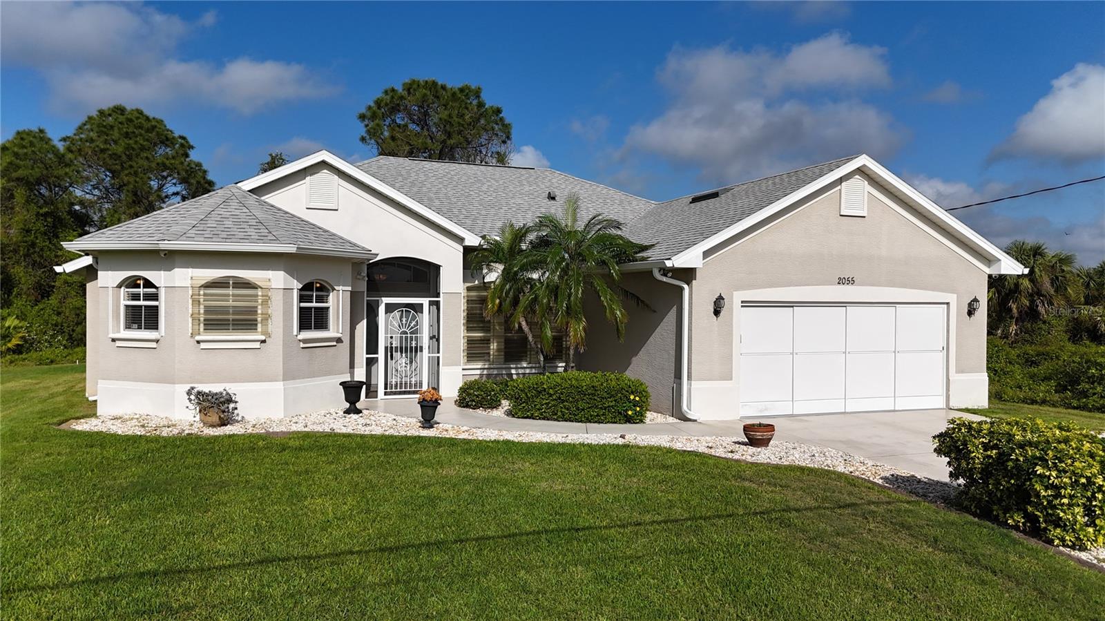*PLEASE TAKE A WALK THROUGH YOUR NEW HOME WITH THE 3D VIRTUAL TOUR* Are you looking for a well maintained, move in ready Florida Style Home on NEARLY 1 ACRE? Look no further – You’ve found it! This centrally located, 3-bedroom, 2-bathroom, 2-car garage CUSTOM home on 4 LOTS in North Port has everything you’ve been looking for! You'll also enjoy peace of mind with a NEW ROOF & new gutters (2024), newer A/C (2022), newer hot water tank (2021) and new well pressure tank in 2022! Pull into the driveway and be greeted with beautiful, lush landscaping that has green grass, curbing, pebble rock and the scent of flowers in bloom. A screened in front porch welcomes you, where you can sit & unwind while enjoying all the beautiful weather Florida has to offer. Open the front door to be met with an inviting and spacious Great Room with neutral paint colors, high ceilings & doorways, making this the perfect blend of comfort, style, luxury, and convenience. The gourmet kitchen boasts an abundance of cabinet and counter space, closet pantry, plant shelves, recessed lighting, ornate backsplash and a well-appointed breakfast bar that houses additional seating options for guests and family alike. Did I mention that all of the APPLIANCES are included in the sale - - this kitchen would make any chef happy! The quaint dinette area flows seamlessly together with the kitchen and makes the perfect spot to sit and enjoy your morning cup of coffee while getting ready to start your day. Picturesque front windows align the dining room, the ideal gathering spot where you can entertain or enjoy a home cooked meal with family and friends. Retreat to the primary suite, which is both comfortable and spacious and houses private lanai access, double walk-in-closets and an en-suite master bath, that offers dual vanities, private toilet closet, garden bath and Roman walk-in-shower with dual showerheads, offering the tranquil relaxation you deserve! The guest bedrooms are across the home in this desirable split bedroom floor plan. Bedroom #2 is equipped with a private closet, ceiling fan and window. Bedroom #3 is currently being used as a den but has doors and a closet alcove making it easy to change it back to a bedroom. A well-appointed guest bathroom with shower/tub combo, vanity and toilet is in between the bedrooms for added convenience. Sliding glass doors lead you out to your backyard oasis, take a dip and unwind in your private hot tub, grab a good book and relax or just enjoy the sunshine right from your own backyard! No deed restrictions or HOA fees. The terrific location of this home allows QUICK access to the Coco Plum Shopping center, golfing, and restaurants. Close proximity to the beautiful Gulf Beaches including Boca Grande & Englewood. Also nearby, Charlotte Harbor and the Gulf of Mexico where fishing is plentiful! Love Baseball? Charlotte Sports Park, home of the Tampa Bay Rays baseball spring training and the BRAND NEW Wellen Park area where you can watch an Atlanta Braves spring training baseball game, shop, dine out or enjoy a Sunday at the Farmers Market are just a short drive! US-41 and Interstate 75 allow you quick access to the North or South. Include this home on your "Must See List" and start packing!