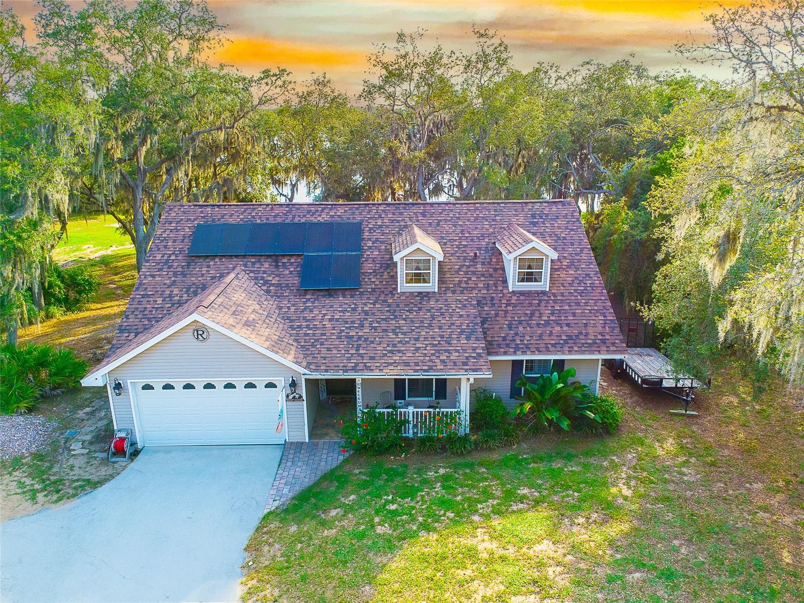 *** PRICE REDUCTION *** Welcome to a Lakefront Oasis. Vacation home, Airbnb or primary residence enjoy this single-family home on Lake Aurora just a few minutes outside of town. Escape to this spacious 3-bedroom plus a loft, 2.5-bathroom with 2 car garage lakefront retreat, perfectly blending comfort and serenity. Sitting on over 1-acre wooded lot, with its own private dock and boat ramp, this property offers direct access to the lake for boating, fishing or simply enjoying the water views. Lake Aurora is a clean, sand bottom lake perfect for swimming and water sports, making it an ideal place for water enthusiasts and nature lovers alike. Unwind and relax in the private above ground pool, perfect for hot summer days or sunset gatherings. Pool motor, liner and timer were replaced in 2023.
Benefit from roof and insulation installed in 2021, improving energy efficiency and comfort, providing peace of mind and protection for years to come. Solar panel system installed in 2022, saving on energy costs. Reliable power backup with the property’s own generator, ensuring power continuity. The plantation shutters were installed in 2023, allowing for easy adjustment of light and airflow. A whole-home air purifier HALO system was installed in the A/C to improve air quality. Well water softener system also included. Keep your tools and equipment organized in the metal storage shed on site. For those looking for more storage or extra garage space there is also a 16x21 metal building located on the property.
The property features 3 bedrooms, 2.5 bathrooms and an upper-level loft overlooking the main floor that can be converted to an additional bedroom, offering ample room for family, friends or guests. Enjoy the lake views from the living room or the master bedroom, both with sliding doors that open onto the covered patio area. The master suite has whirlpool tub and separate shower. An open terrace surrounded by the serene beauty of Lake Aurora perfect for BBQ gatherings, sunset appreciation or relaxation. Cozy up on chilly evenings in the living room with the customized electric fireplace built in 2023. The kitchen refrigerator was replaced in 2022, dishwasher and microwave were replaced in 2024. The property also features a 2-car garage with epoxy flooring, perfect for parking your vehicle or working on projects. Schedule a viewing today and make this incredible lakefront property yours!