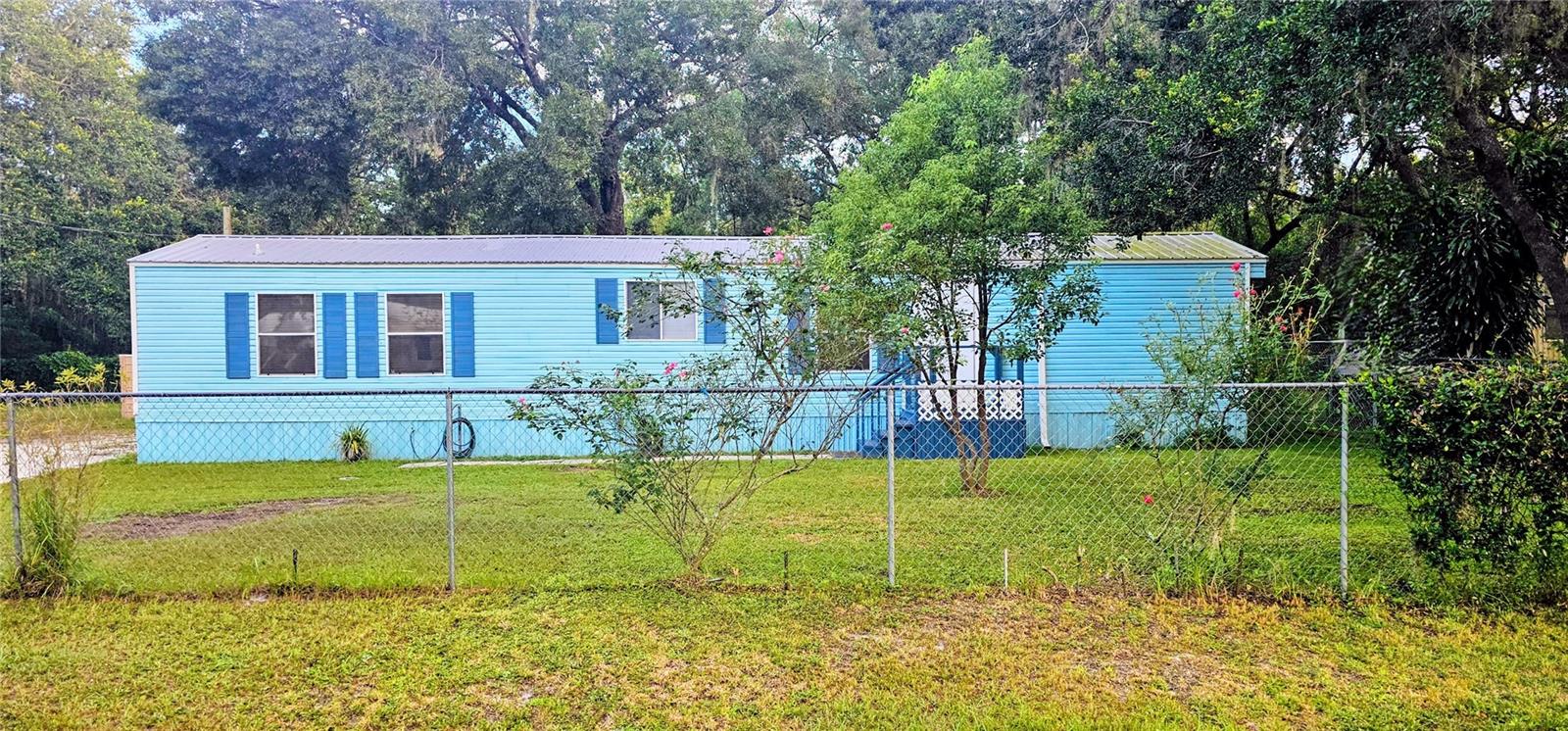 Welcome to your dream home! NO HOA or Lot Rent. Down Payment/Closing Cost Assistance with HomeTown Heroes Program! USDA Eligible! This charming 1994 home is situated on a half-acre of dry, high-fenced land, providing the perfect blend of comfort, space & security. The home boasts a 2016 durable metal roof, new Pergo waterproof laminate flooring, updated Cold AC, 50 gallon 2023 water heater, fresh paint inside & out, ensuring both durability and luxury. Perfect for entertaining with open floorplan with large kitchen, breakfast bar, living room, split-bedroom layout and large, screen/window back porch with brick extended patio and outdoor brick grill.
One of the highlights of this home is its prime location, backing up to over 300 acres of tranquil woods. Say goodbye to backyard neighbors and look forward to waking up to the sounds of nature, enjoying your morning coffee in a peaceful setting.
But that's not all! Calling all car guys! The property comes with a Huge 24’ x 24’ x 13.6’ high INSULATED metal garage that is 150 mph hurricane wind resistant on a slab with every post 4 ft deep in concrete. It provides ample space & electricity for a shop to work on your cars, RV, boat, recreational toys, storage or a home business. Plus, there is a carport on slab attached to another shed for combined area 43’ x 45’ attached to privacy fence shielding the back yard. You finally have freedom & privacy without the constraints of an HOA, which is a rare find! Irrigation system in front and back yard.
Conveniently located with easy access to the Parkway & i-4, making commutes to Lakeland, Orlando or Tampa a breeze.
Don't miss out on this fantastic opportunity – make this home yours and embrace a lifestyle of comfort, tranquility, and freedom. No HOA means no restrictions – just the way you want it! Call today to schedule your private showing!