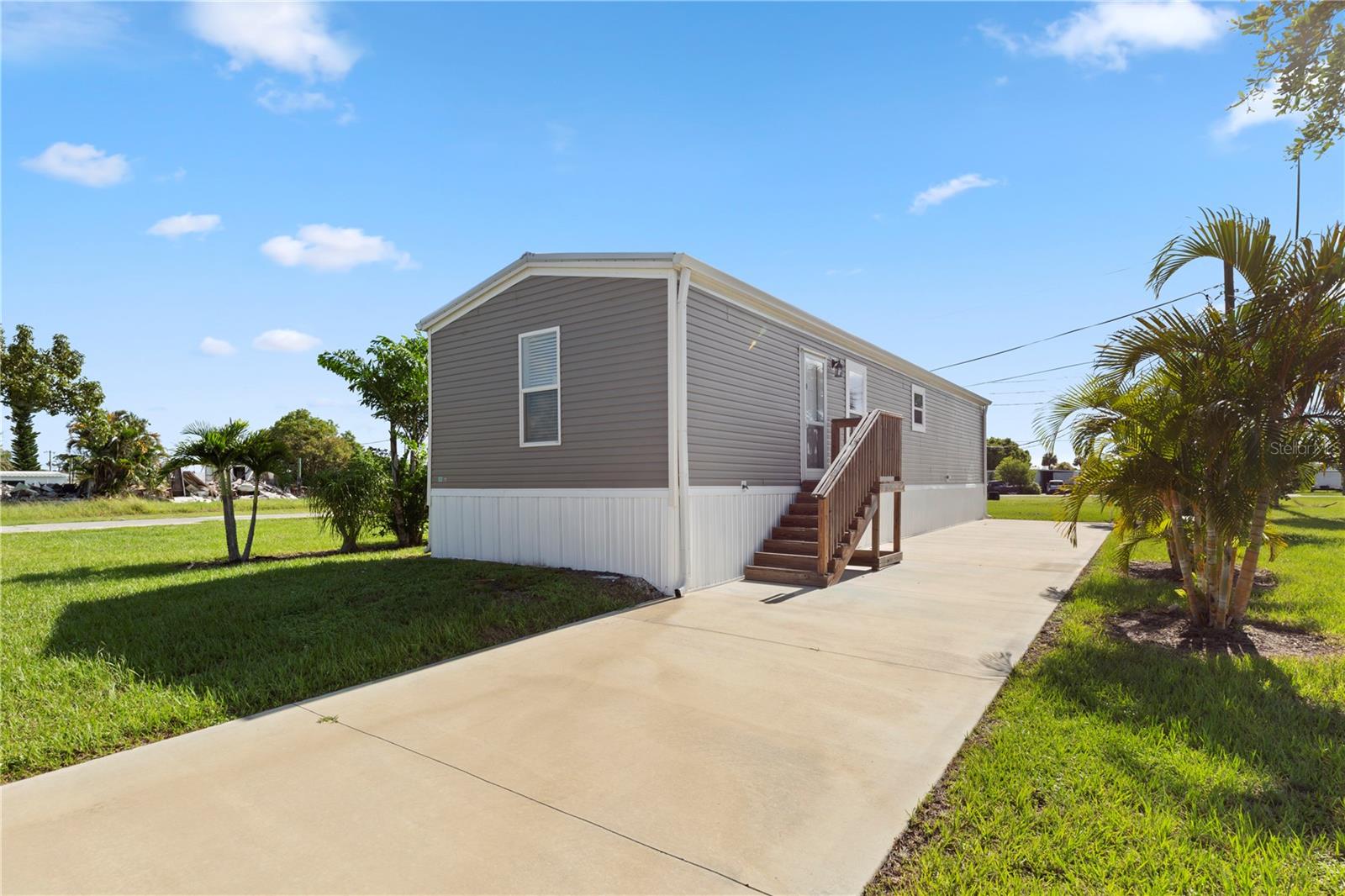 NEVER LIVED IN, 2023 BUILD 2 Bedroom, 2 Bathroom, Mobile home located in the active 55+ Manatee Cove community. LOW HOA FEES! CLICK ON THE VIRTUAL TOUR LINK 1 FOR THE VIDEO AND VIRTUAL LINK 2 FOR THE 3D TOUR. Featuring a bright & open floor plan, luxury vinyl flooring throughout, recessed lighting and MUCH MORE! Spend quality time with friends and family with an open living room while whipping up family favorites in the kitchen. The kitchen offers ALL Stainless-steel appliances, a stainless-steel farmhouse sink, and a center island with a breakfast bar. The spacious master suite has a walk-in closet and an en-suite bathroom with a single sink vanity and a walk-in shower. The guest bedroom is on a split floor plan, providing plenty of privacy, with a built-in closet and a guest bathroom nearby. The yard has been newly professionally graded and sodded. Manatee Cove of Englewood is a deed restricted neighborhood has a clubhouse with shuffleboard courts with the option of enjoying the amenities of the active Englewood Club where they have a community pool, pickleball, and bocce ball, shuffleboard, and many clubs and community activities. Conveniently located near shopping, fine & casual dining spots, LIVE entertainment, biking, and boating. JUST A SHORT CAR RIDE to the Gulf Beaches of Lemon Bay, Englewood, Boca Grande, or Manasota Key to name a few where you will find world-class fishing. Schedule your showing TODAY!!