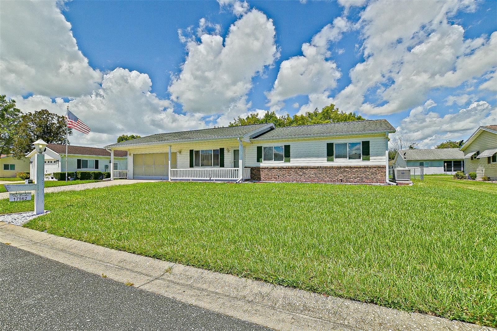 Welcome to Easy Living in Spruce Creek South! This nicely maintained 1008 SF Pecan model is full of charm and features that make it a standout value. Step inside and be greeted by vaulted ceilings for a bright open feeling. The vinyl plank flooring in the kitchen and dining area adds practicality, while cozy carpet in the living spaces invites relaxation. Enjoy extra living space and comfort in the spacious 15' x 10' lanai, featuring newer acrylic sliding windows and a tiled floor—perfect for morning coffee or casual gatherings. Outside, the fenced yard offers privacy for pets or gardening, and the oversized garage extended by 2 feet adds extra room for storage or workspace. Major updates include a new roof (2012) and A/C (2012) for peace of mind. Located in Spruce Creek South, a gated, golf course community brimming with amenities and activities to suit every interest. Just minutes from shopping, dining, entertainment, and medical facilities—everything you need within easy reach. Priced to sell and ready for a new owner—don’t miss this affordable opportunity in one of the area’s most vibrant communities! (Most furniture available separately).