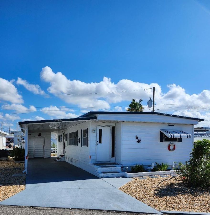 Open and spacious Living and Dining areas in this 2 Bedroom, 1 1/2 Bath Mobile Home in the highly desired 55+ Trailer Estates waterfront community. Just a block to access the community pool, recreation buildings, shuffleboard, fitness center, and all the wonderful park amenities. New luxury vinyl plank floors throughout; new subfloors throughout. Master Bedroom has plenty of closets, built-in drawers and ensuite Half Bath. Laundry/utility shed with washer/dryer, has space for storage. A/C and ducting new 2024. You own the land. Boaters have direct access to Sarasota Bay from your doorstep, or the Trailer Estates Marina. Enjoy the large, heated community pool, hot tub, gym and wood shop. The community buzzes with pickleball, shuffleboard, kayaking, horseshoes, bocce, dancing and more. A US Post Office on site. 10 minutes to Sarasota-Bradenton Int'l Airport. Convenient to shopping, restaurants, the Arts and everything in Bradenton/Sarasota.