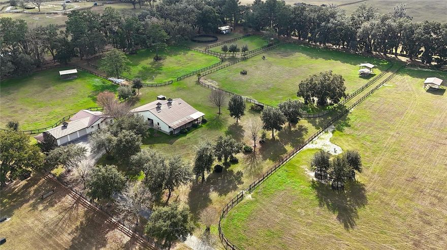 Perfectly positioned 20+/- acres off the highly desirable 225A corridor, this exceptional equestrian property offers a rare combination of quality construction, scenic views, and prime location.  Rolling pastures and long-range vistas set the tone as you arrive at this thoughtfully designed farm, ideal for both private use and professional operations.
The property features an 8-stall concrete block barn, complete with well-appointed living quarters, including a one-bedroom layout, open kitchen, and inviting living and dining areas.  A covered front porch overlooks the center aisle, perimeter fencing, and surrounding pastures, creating a picturesque and functional equestrian environment.  The barn also includes a generous side overhang, providing flexibility for equipment storage, additional work areas, or future expansion. 
The main residence is complemented by an attached three car garage.  Positioned on NW 80th Avenue, just minutes from Ocala's premier equestrian venues, this elevated farm delivers privacy, accessibility, and enduring value, an exceptional offering in one of the region's most sought-after equestrian corridors. 12 minutes from the World Equestrian Center and close to HITS.
