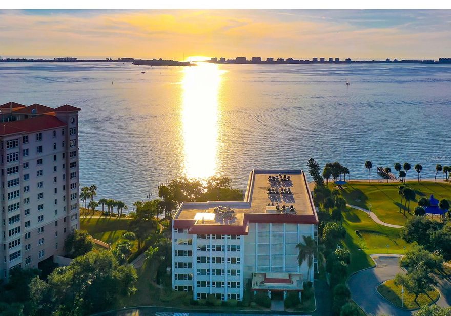 Enjoy views of Sarasota Bay from every windows in this ideally situated condo through the graceful branches of a mature live oak tree. Located in the desirable Bay’s Bluff community, this well-maintained home’s split floor plan offers a spacious living and dining area, open to the adjacent kitchen. Hurricane-impact windows provide peace of mind and the large primary suite features an ensuite bath, plantation shutters and a walk-in closet.  Sit out on your private screened lanai and watch the seabirds, sailboats, and breathtaking sunsets. Or relax at the water’s edge in an Adirondack chair on the community’s 267-foot private seawall, where the soothing sounds of the bay will calm your mind and spirit. 
Bay’s Bluff is a charming, pet-friendly mid-rise community. The bayfront heated pool and grill area are ideal for hosting a sunset cocktail party or cookout.
This community shares an entrance with Whitaker Gateway Park—with its fishing pier, walking paths, and picnic areas.  And you’ll find Publix just across the street for ultimate convenience.
Just two blocks from The Bay Park, Sarasota’s 53-acre cultural and waterfront destination, and only one mile from downtown Main Street, you’ll have easy access to world-class dining, theaters, museums, shopping, Sarasota-Bradenton Airport, and award-winning beaches.
This is the best direct waterfront value in all of Downtown Sarasota—an unbeatable lifestyle and location.