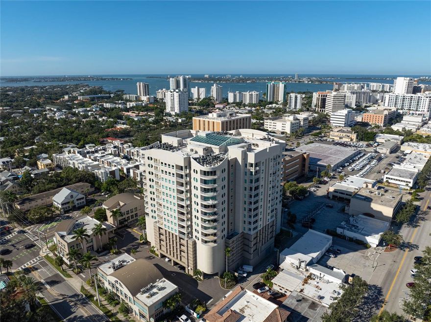 One or more photo(s) has been virtually staged. Experience sophisticated urban living in this spacious 7th-floor corner residence at Rivo at Ringling in downtown Sarasota. The open layout features beautiful wood floors, a modern kitchen with wood cabinetry, granite countertops, breakfast bar, and stainless steel appliances. Enjoy a large private terrace with northeast city and partial bay views—perfect for relaxing or entertaining.
This residence includes a large laundry room with extra storage and full-size washer and dryer, plus updates such as a top-of-the-line Trane A/C (2023) and a frameless glass shower in the primary bath.
Rivo’s resort-style amenities include a heated pool and spa, fitness center, BBQ terrace, social and conference rooms, concierge services, bike and kayak storage, and EV charging stations. Two deeded, secure parking spaces and an oversized storage room complete this rare offering.
Steps from fine dining, shopping, and Sarasota’s cultural attractions, Rivo at Ringling combines luxury, location, and lifestyle in one exceptional address.