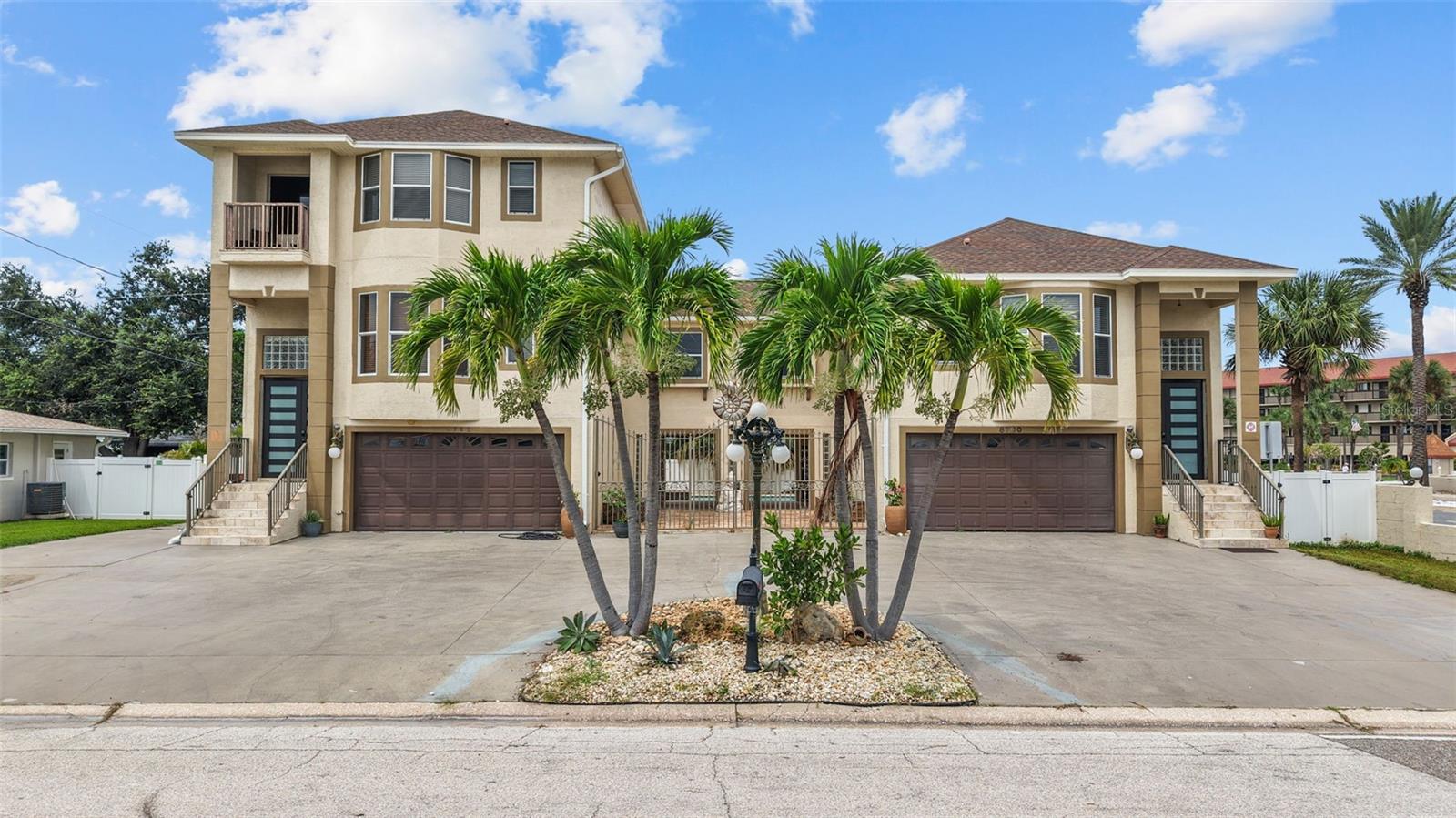 Step into a true slice of paradise with this stunning beachside duplex, which could also serve as a single family home located just moments from the iconic white sands of St Pete Beach. This exceptional property offers two distinct living spaces—each brimming with charm, comfort, and versatility.
The larger unit spans three thoughtfully designed levels and includes three spacious bedrooms, four bathrooms, and a versatile efficiency unit on the ground floor. The gourmet kitchen is a showpiece, featuring real wood cabinetry, gleaming granite countertops, a generously sized island, and stainless steel appliances. Artistic lighting and recessed fixtures create a warm and welcoming ambiance, while textured ceilings add character. The third level unveils two oversized bedrooms with private balconies overlooking the neighborhood and offering views of the Gulf. The master suite boasts a luxurious bathroom with a jacuzzi tub, stand-up shower, and a walk-in closet designed to impress.
Next door, the second unit offers its own flair with two bedrooms and two bathrooms, including a primary suite with rich plank bamboo flooring, a spacious closet, and a bathroom wrapped in elegant marble finishes. The kitchen is equally functional and stylish, with a central island offering plenty of storage, washer/dryer hookups, and a balcony that invites you to unwind while gazing out over the pool area.
Outside, the property transforms into a tranquil oasis. The sun-drenched courtyard features a shimmering swimming pool and a spill-over jacuzzi, all framed by gold travertine pavers laid in a classic French Pattern. Tropical landscaping sets the tone, while a Pebble Tech pool finish and custom blue glass waterline tile elevate the setting. A Generac generator stands ready for stormy days, and a separate shed offers easy storage for yard tools and beach cruisers.
Centrally located near top-tier dining, vibrant shopping, and, of course, Florida’s world-renowned beaches—this income-producing gem captures the essence of coastal living. Don’t let this rare opportunity drift away!