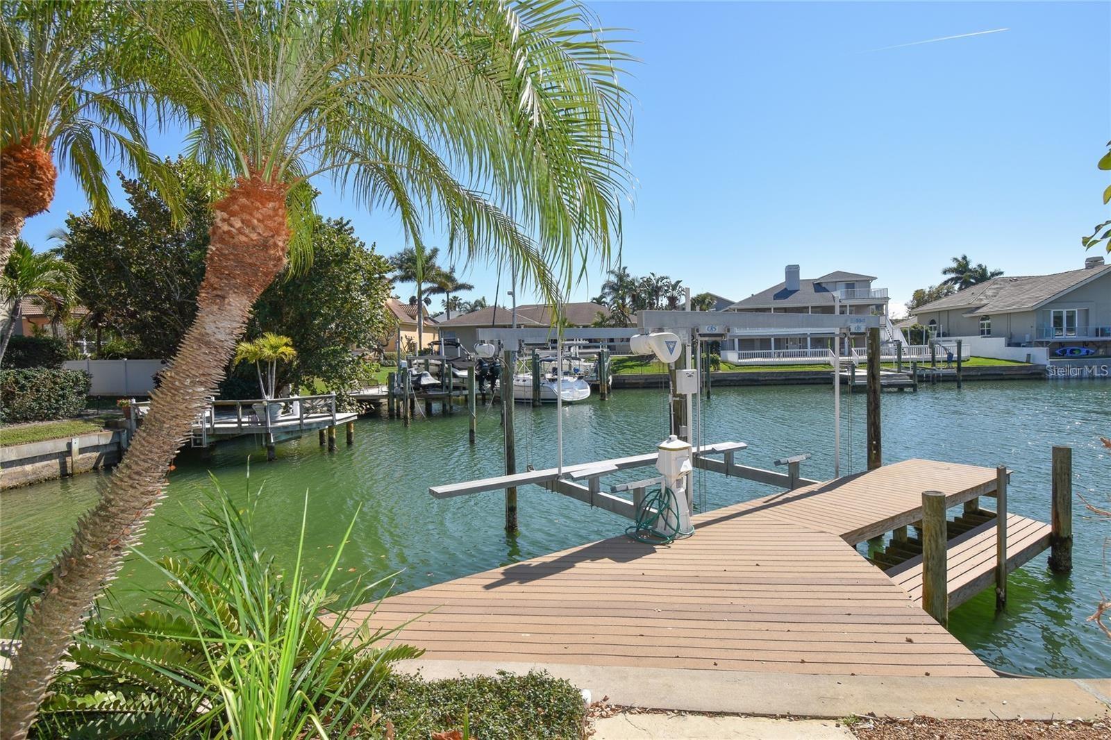 Available for immediate Occupancy! WATERFRONT with Boat Dock & Lift. Tudor Style Estate Home in Sands Point on the Beautiful Island of Tierra Verde. Newer flooring, fresh landscaping, newer vanities in guest baths, newer washer/dryer/laundry tub and much more. High quality construction and meticulous attention to detail describes the very spacious 4 bedroom, 4&1/2 bath home. Looking for lots of space? You have found it! Formal Living, Formal Dining, Large Kitchen, Dinette, Family Room w/bar: newer wine refrigerator and beverage fridge, Office and 3 Bonus rooms! multiple HVAC systems; kitchen features SS appliances & tile backsplash, quartz counters, and quality porcelain flooring Impact-rated thermal windows with UV protection; impact-rated garage doors with new garage door openers, pebble-finish pool. Textured concrete driveway and pool deck; Expansive composite dock w/kayak ramp and 16k lb. boat lift. Exterior Elevator/Lift servicing all 3 levels. Main level of living features living room with fireplace gorgeous water views from formal dining room, piano/parlor room, bright open kitchen and dinette. Kitchen has a breakfast bar opening to the family room. Large private office off the foyer. Private guest bedroom with ensuite bath located on the main floor. Multiple sets of French doors open unto a huge wrap-around "renovated" waterfront balcony overlooking the sparkling pool. Upstairs you'll find the Primary suite retreat w/huge ensuite bath (double pedestal vanities, massive tub, separate shower, dressing area, private water closet. MBR also features a private waterfront balcony. 2 generous walk-in closets for plenty of storage. Two additional spacious bedrooms and full bath complete this level. Lower level has two bonus rooms with new ceramic tile flooring. Great gym, game room or man cave. Bonus is the cedar-lined sauna. Back yard has very large covered patio, swimming pool & full bath for outdoor entertaining. Three car garage and tons of additional storage/ workshop space. Enjoy the Island lifestyle featuring Marriott Hotel’s rooftop Vista at the Top w/360-degree Views of the water and Skyway Bridge, Other restaurants include Island Grille & Billy’s Stone Crab where you can enjoy live music nightly. Seaworthy and other wonderful restaurants, Italian fare to French Cuisine & More! Fort Desoto Park/Beaches in your backyard. World’s Most Famous St. Pete Beach is a short drive. Minutes to Vibrant downtown where you can catch a Rowdies soccer match. Visit the World Class Museums including The Dali. PROFESSIONAL PHOTOS COMING SOON.