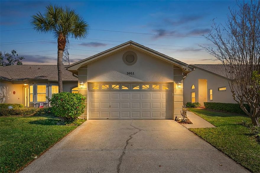 Experience effortless Florida living in this meticulously maintained villa located in the highly sought-after Brookfield community. From the moment you enter, soaring ceilings and an open-concept design fill the home with natural light, creating a warm and spacious atmosphere. At the heart of the living area, a wood-burning fireplace becomes an inviting focal point—perfect for cozy evenings and relaxed gatherings. The kitchen is thoughtfully appointed with 42-inch cabinets, crown molding, granite countertops, and stainless-steel appliances, offering timeless style and ample storage. Luxury vinyl plank flooring flows throughout the home, adding durability and a cohesive, modern feel. Both bathrooms have been fully remodeled and feature brand-new custom vanities with granite countertops, along with custom built-in cabinetry for added functionality. The screened-in lanai expands your living space outdoors, while the private pavered backyard provides a peaceful retreat ideal for entertaining or unwinding in the evenings. The primary suite includes a walk-in closet, and the third bedroom is well-suited for a home office, den, or nursery. An interior laundry room adds everyday convenience. The garage is well equipped with built-in storage cabinetry, pull-down attic access, and attic lighting—ideal for organization and additional storage needs. Brookfield residents enjoy exceptional amenities, including two community pools (one heated), tennis and pickleball courts, and a clubhouse, all for a low HOA fee of $325 a month. Ideally located approximately 34 minutes from Tampa International Airport, 30 minutes from St. Pete–Clearwater (PIE) Airport, and just 30 minutes from Clearwater Beach, consistently ranked among the best beaches in the United States. This move-in-ready villa offers comfort, convenience, and an unbeatable location—don’t wait, this one won’t last.