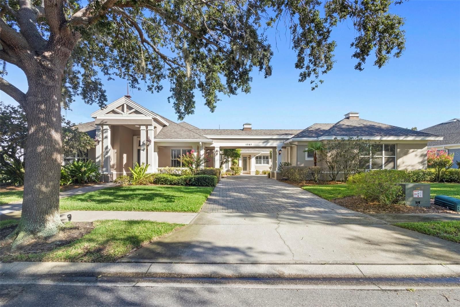 Welcome to this beautifully maintained, custom-built residence in the gated golf community of Kissimmee Bay. Perfectly positioned on the golf course with serene water views on two sides, this home offers both privacy and a remarkable setting. From the inviting front porch to the expansive wraparound screened porch overlooking the water and fairways, every detail was designed to enjoy indoor-outdoor living. A pavered driveway leads to not only an attached two-car garage, but also a detached garage with workshop space—an ideal setup for hobbyists or additional storage. Inside, the thoughtful floor plan begins with a formal dining room connected to the kitchen by a convenient butler’s pantry. The spacious living room is filled with natural light and showcases panoramic views, along with direct access to the porch and a well-appointed wet bar. The kitchen features granite countertops, tile backsplash, double breakfast bars, abundant storage—including three pantries—and a built-in oven, creating a true chef’s workspace. The split-bedroom design offers privacy, with two secondary bedrooms sharing a Jack-and-Jill bath and a flexible office/den that also opens to the back porch. The primary suite is a retreat of its own, complete with peaceful views, private porch access, and a spa-like bath with soaking tub, dual sinks, and separate shower. Ample storage is found throughout the home, including multiple hallway closets and a generous laundry room with cabinet and counter space. Outdoors, the wraparound screened porch offers endless opportunities to relax or entertain while enjoying tranquil water and golf course views. Off of the porch you will enjoy having a fenced area for your furry friends or to garden! For your peace of mind there is a whole house generator and hurricane shutters. The roof was replaced in 2018. The Kissimmee Bay Golf Course and Country Club is rich with amenities! Enjoy the golf course, tennis courts, pickleball, courts, playground, private water access with boat ramp to East Lake Toho, marina, RV and boat storage, and more—all in a prime location near excellent schools, shopping, and dining. This home offers a rare balance of comfort, space, and timeless appeal in one of Kissimmee’s most desirable communities. Schedule your private showing today.