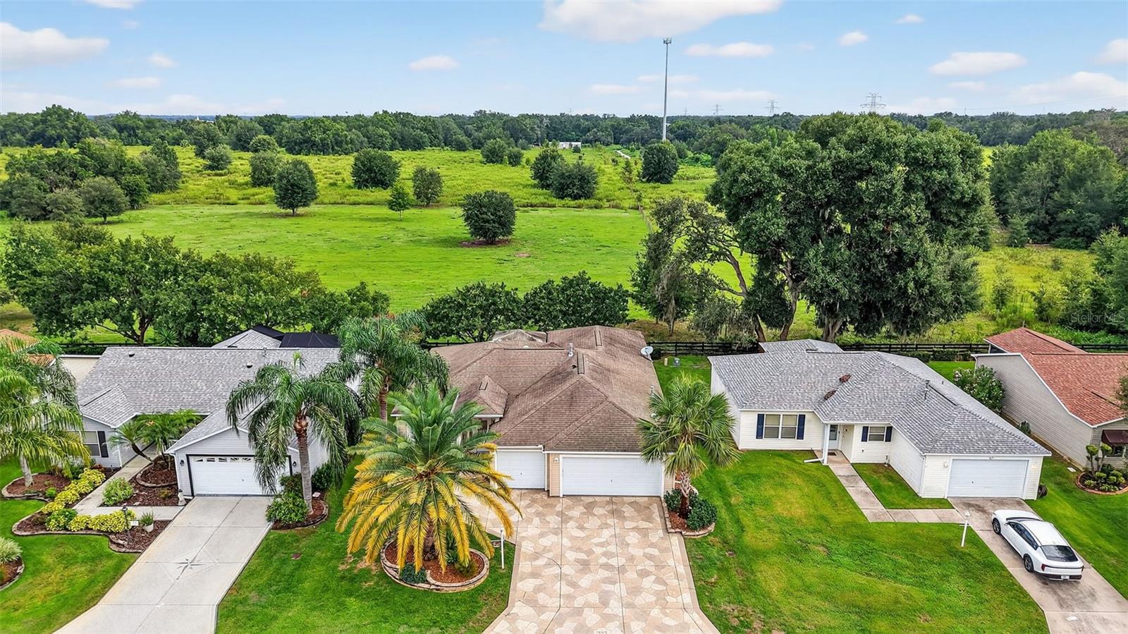LOOKING FOR PRIVACY? WELL...HERE IT IS, IN THE VILLAGES FL!
This EXPANDED Amarillo with BONUS ROOM & EXTRAS throughout delivers it in a BIG way.
This 3-bd, 2-bath, 2-car garage + EXPANDED Golf Cart garage is tucked away on a QUIET CUL-DE-SAC road in the sought-after VILLAGE OF CAROLINE. From the moment you step out back, you’ll see what makes this home truly special, it backs to a TRANQUIL PRESERVE VIEW with no golfers, no golf carts, and no golf balls… JUST PEACE & QUIET!
From the curb, you’ll notice the beautiful landscaping and decorative stamped driveway. Step through the glass entry door into a 6' EXPANDED Living Room & wide open floor plan with VAULTED CEILINGS and a solar tube FILLING the home with natural light.
The kitchen is a chef’s delight, featuring granite counter tops, rollout cabinet drawers, NEWER LG STAINLESS STEEL APPLIANCES (2022), a 5-burner gas stove, and a TOUCHLESS faucet.
The split floor plan provides a PRIVATE guest suite with two SPACIOUS 13’x12’ bedrooms and a guest bath with granite counters and tub/shower. On the opposite side, the MASTER SUITE offers a LARGE 15’x13’ bedroom with his&her WALK-IN CLOSETS, dual granite vanities, a ROMAN shower with built-in bench and shelves, and a PRIVATE water closet.
An EXPANSIVE 19’x12’ BONUS ROOM doubles as a den or guest space with a BUILT-IN desk for 2 and a FULL-SIZE Murphy bed. The inside laundry includes washer & dryer, leading into the EPOXY-FINISHED 2-car garage with utility sink, ELECTRIC garage screen door, and EXPANDED golf cart garage.
Outdoor LIVING is where this home SHINES: a 14’x9’ FLORIDA ROOM, 19’x8’ LANAI (both under A/C), and an 11’x15’ COVERED BIRDCAGE WITH LIGHTING, all overlooking the TRULY UNIQUE PRESERVE VIEW.
LOCATION HIGHLIGHTS: • 1 mile to Lake Sumter Landing Square • 0.5 mile to Coconut Cove Recreation Center (family pool, tennis, pickleball & more) • 1.5 miles to Mallory Country Club
MAJOR UPGRADES: • HVAC (2023) • Water heater (2019) • NEW ROOF TO BE INSTALLED BEFORE CLOSING! (2025)
VERY LOW BOND BALANCE: $6,134.43