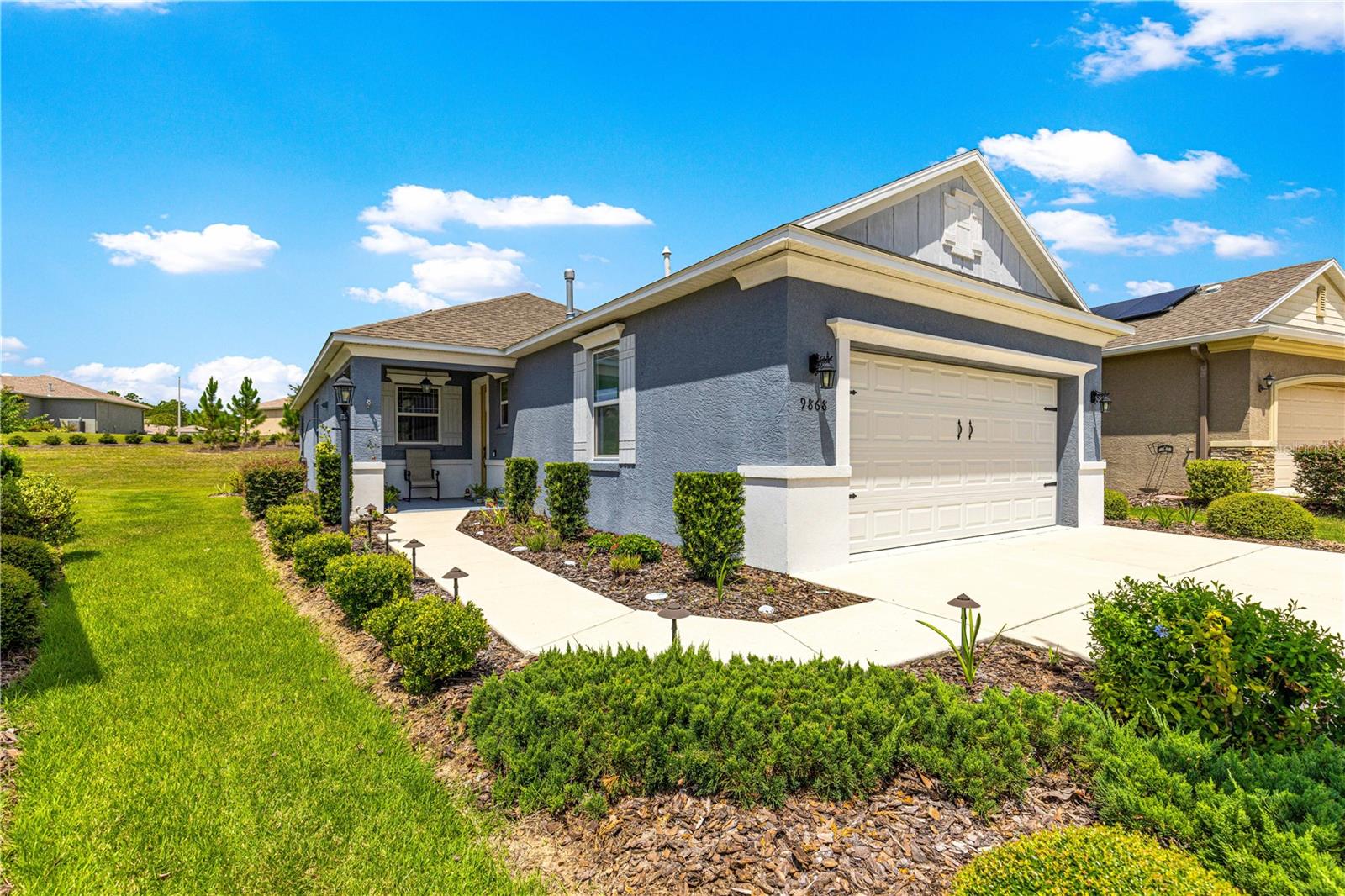 SOLAR EQUIPPED SMART HOME! Spacious Tamar Model Single Family Home with 2 Bedrooms, 2 Baths, Flex Room, & 2-Car Garage on a PRIVACY LOT WITH GREEN SPACE in the Crescent Ridge 3 Neighborhood of On Top of the World, Premiere 55+ Gated Golf Community in SW Ocala FL. Thanks to the builder installed 14 panel SOLAR system the average monthly electric bill is less than $35. Solar Panels are 100% paid for and fully transferrable! Natural gas provides cooking, heating, dryer, & water heater energy! As you approach notice the extended driveway, the cute front porch, and the GREEN SPACE in front! The RING doorbell conveys with the home. Step into the foyer and immediately notice the Flex Room with closet and window, being used as formal dining room with custom chair rail. The entire interior of the home was custom painted in two tone neutral beige colors. Dedicated laundry room with washer, NEW gas dryer, and storage are steps from the entrance to the 2-car garage. Down the short entrance foyer/hall step into the GOURMET Kitchen w/beautiful granite counters and tile backsplash, custom pantry with extra storage on the door, upgraded appliances including NEW microwave, a window over the sink, and counter peninsula w/seating. The oversized Great Room is perfect for entertaining! Split bedroom plan with guest bedroom (currently used as a Den) to right of kitchen provides a true guest suite with adjoining guest/hall bath with tub & tile surround, quartz vanity top, and comfort height toilet. The spacious primary bedroom is in the back of the home for privacy with ceiling fan and large window. The massive walk-in closet has been upgraded with double hanging rods. The en suite bath has a LARGE step/roll in upgraded tiled shower with seat and glass enclosure, double vanity w/quartz top, comfort height toilet, and linen closet. Step through the slider to the screened lanai w/ceiling fan and enjoy the GREEN SPACE in back – perfect location for your morning coffee. The 2-car garage includes a whole house water filtration system, a rough-in for laundry sink and LOTS of storage! The monthly HOA fee includes DCM Basic Internet, roof repair, exterior painting every seven years, exterior maintenance and insurance, landscaping, trash & recycling, 24/7 monitored gates and all the amenities that OTOW has to offer; three pools (2 outside & 1 inside & another under construction), two state of the art fitness centers, pickleball, billiards, archery range, corn hole, bocce ball, tennis, shuffleboard, horse shoes, remote control flying field and race cars, 175+ clubs, woodworking shop (extra fee), library, and much, much more! A golf cart community with access to three shopping centers. Centrally located 20 minutes from the World Equestrian Center, easy drive to 4 cruise ports and/or airports, and within a close proximity to entertainment complexes in Orlando.