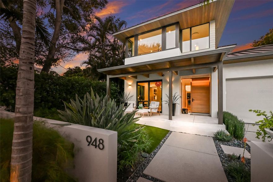 The Epitome of Refined Coastal Luxury in Bungalow Hill:  This custom-built Edgewater residence offers a pristine living space crafted with meticulous attention to detail and consistent luxury throughout. Its sleek façade invites you into a world where modern elegance meets tropical serenity. Inside, sunlight pours through expansive windows, dancing across wide-plank Spanish White Oak floors. The open-concept living area flows effortlessly under soaring ceilings, complemented by motorized shades that balance light and privacy. At the heart of the home, a gourmet chef’s kitchen is the centerpiece – featuring high-end appliances hidden behind sleek cabinetry, pristine quartz countertops, and a dramatic waterfall island designed for culinary artistry and entertaining. The layout blends open gathering areas with private retreats. The main-level Owner’s Retreat offers an unparalleled sense of serenity, with a spa-inspired en-suite featuring a lavish recessed rain shower, a freestanding soaking tub, and designer fixtures. Upstairs, a second primary suite ensures family and guests enjoy equal comfort and privacy – complete with a private balcony, a tranquil haven for morning coffee or evening breezes. The home’s dedicated spa-inspired wellness area, with a private sauna and cold plunge, offers an immersive environment for restorative living and the ultimate escape for those seeking refined relaxation and wellness. Additionally, a club room provides flexible space as an executive office by day or a media lounge by night, with direct outdoor access. Resort-Style Outdoor Living:  Step outside into a luxurious oasis that feels like a private resort. The expansive screened lanai spans the back of the home, ensuring insect-free comfort and framing sweeping views of lush palm trees and the heated saltwater pool. Multiple lounge areas and a covered alfresco dining space provide ample room for relaxed living and lively entertaining. Fire up the grill for poolside BBQs, host an outdoor soirée, or simply unwind with a sunset cocktail. The resort-style pool offers a private island escape, surrounded by tropical greenery for utmost seclusion. Whether you’re soaking up the sun on a chaise or chatting with friends in the shade, this outdoor haven makes every day feel like a vacation. Prime Location & Lifestyle:  Nestled on a quiet dead-end street in prestigious Bungalow Hill — a highly sought-after West of Trail/West of Osprey enclave — this home offers peaceful privacy while being just moments from downtown Sarasota, the best of both worlds. In this golf cart-friendly neighborhood, you’re a short ride from Marie Selby Botanical Gardens, Marina Jack and Bayfront Park. Downtown Sarasota’s boutique shopping, art galleries, theaters, and fine dining are all within a mile, as is the charming Southside Village — home to the iconic Morton’s Gourmet Market and a variety of restaurants and bars. Sarasota Memorial Hospital is also less than a mile away. Plus, the property is zoned for the coveted Southside School District, putting top-rated schools, cultural attractions, and waterfront events within easy reach. This property embodies the ultimate coastal lifestyle, perfect for cherished family memories or substantial rental income, thanks to its short-term rental zoning within Sarasota’s city limits. This is the ultimate retreat for the discerning buyer seeking sophistication and relaxation – a rare opportunity where privacy, luxury, and location converge.