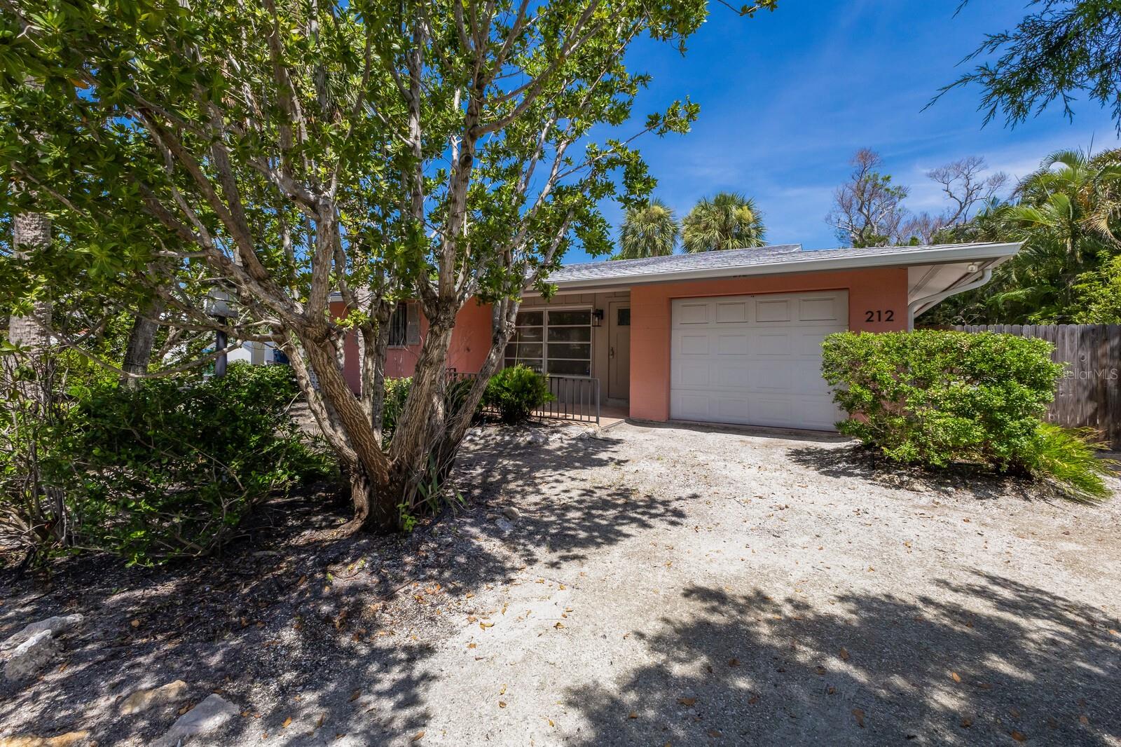 Discover the potential of this charming 2BD/2BA home with a bright Florida room offering a clean slate for your creative vision. Freshly opened up inside and waiting for your personal touch, this coastal residence provides the perfect canvas to reimagine every detail from floor to ceiling. Located in a desirable weekly vacation rental zone, and a short stroll to the beach, it presents an exceptional opportunity for both personal enjoyment and income potential. A one car garage adds convenience and storage, while the private backyard retreat, featuring an inviting L-shaped lap pool, becomes the ultimate space for relaxation and summer gatherings. With plenty of room to craft your ideal indoor outdoor lifestyle, this home is poised for a complete transformation ready for you to bring it to life exactly the way you’ve always imagined. Don't let this cute little slice of island life slip away and create your island getaway today!