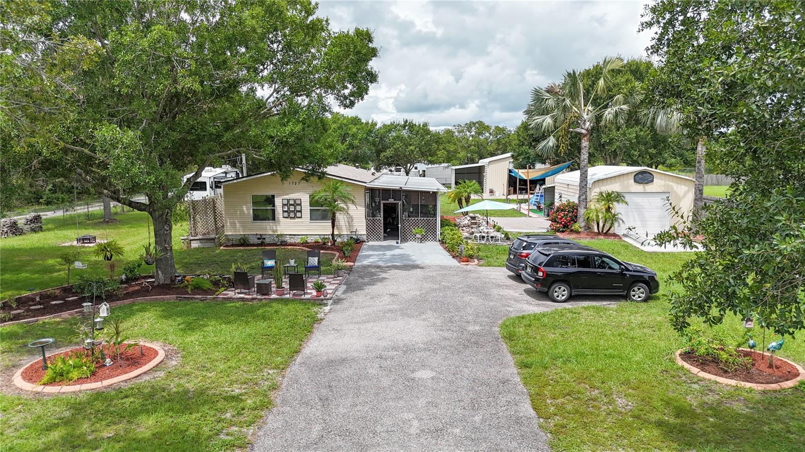 Newly renovated 2-bedroom, 2-bathroom mobile home situated on a quiet dead-end road with exceptional features inside and out. This move-in ready home offers mature landscaping, a fully fenced yard, and a private garden pump house. Enjoy the Florida lifestyle with a sparkling pool, large patio, and dedicated grilling area perfect for entertaining. The property includes a 20x20 detached garage/workshop and a 40x30x40 steel warehouse with 50-amp and 30-amp hookups — ideal for RVs, equipment, or storage. Recent updates include a new roof and A/C (installed 6 months ago), and appliances less than 2 years old. A rare find with privacy, space, and functionality all in one!