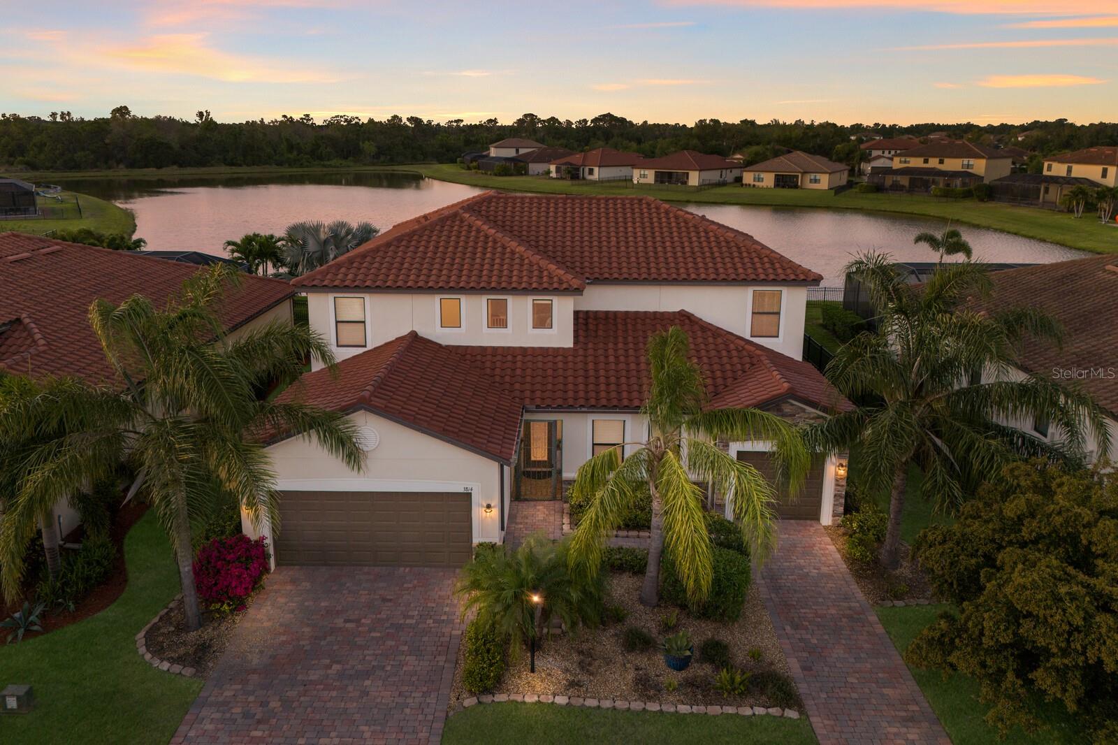 A MUST SEE!! This STUNNING 6 bedroom, 4.5 bathroom, 3 car garage Liberation Model by Lennar, offers 3,899 sq. ft. of thoughtfully designed living space. This "NEXT-GEN" home provides a unique multi-generational living experience with a PRIVATE SUITE featuring its own bedroom, full bathroom, kitchenette, living room, separate entrance, and dedicated garage, making it perfect for extended family, guests, or a private retreat. As you step inside, you’re greeted by an open concept layout with a kitchen/living room combo designed for both function and style. The kitchen is equipped with white cabinetry, granite countertops, a dual sink, stainless steel appliances, a spacious walk in pantry, and an eat-in area with BEAUTIFUL views of the pool. Adjacent is the formal dining room which is ideal for hosting memorable gatherings. The living room, filled with natural light, seamlessly connects to the expansive lanai and pool area through sliding doors, creating a perfect flow for indoor/outdoor living and entertaining. Upstairs, a large loft area with a CUSTOM, built in TV wall entertainment center serves as a perfect media or game room for family fun and movie nights. The SPACIOUS primary suite features a walk-in closet and an ensuite bathroom with a garden tub, dual sinks, and a walk-in glass shower. Four additional bedrooms, two full bathrooms, and a convenient upstairs laundry room complete the second level. The entire upstairs has been updated with luxury plank vinyl flooring for a modern and stylish touch. Step outside to your recently rescreened lanai, where a HEATED SALTWATER POOL and SPA await, making it ideal for relaxing while enjoying breathtaking pond views and serene sunsets. Recent upgrades include a NEW pool pump and salt generator. The three car garage features hanging storage racks, ensuring ample space for organization. Savanna is a fabulous community with LOW HOA resort-style amenities such as a clubhouse, swimming pool, state-of-the-art fitness center, basketball courts, playground, dog park and numerous walking paths. Lakewood Ranch is known for their A+ rated school system and is perfectly located just a short ride to downtown Sarasota, St. Pete, world class shopping, fine dining and the FAMOUS Gulf beaches! Don't wait to make this your home and begin your FLORIDA Lifestyle!