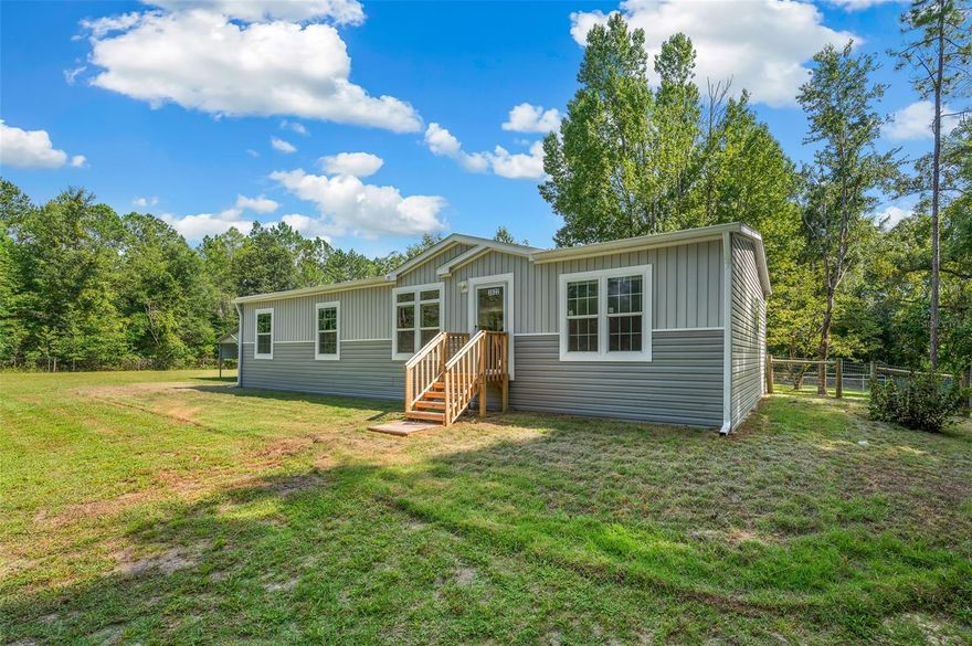 10 Beautiful acres........with 2 Multi-Family Mobile homes on site. 1st PROPERTY is a 1,456 sf 3 bedroom 2 bath  built in 2025.. Features include open floor plan, vinyl plank flooring throughout, dining area, large kitchen with island, all appliances, along with washer/dryer & freezer. Master bath has walk in shower, 2 sink vanity w/separate make up area, walk in closet. Separate laundry room. Fenced in back yard.....open carport...... 2nd  PROPERTY is a 1,248 double wide, 3/2 baths, built in 2012, has an open floor plan. 2 way split. Laundry room w/ washer & dryer. Screened porch on the back, Each property has it's own Septic tank, utilities and address. Both homes share one well. Out buildings: 1st building (Barn) for lawn equipment.  2nd building has open bay garage area.........This property offers a lot of living space across two separate residences, making it potentially suitable for multi-generational living, rental income, or even a home with a dedicated guest house. The acreage provides ample space and privacy. 1st PROPERTY is being sold AS-IS WITH ALL THE FURNISHINGS INCLUDING MOWER.
2nd PROPERTY is being sold AS IS.
